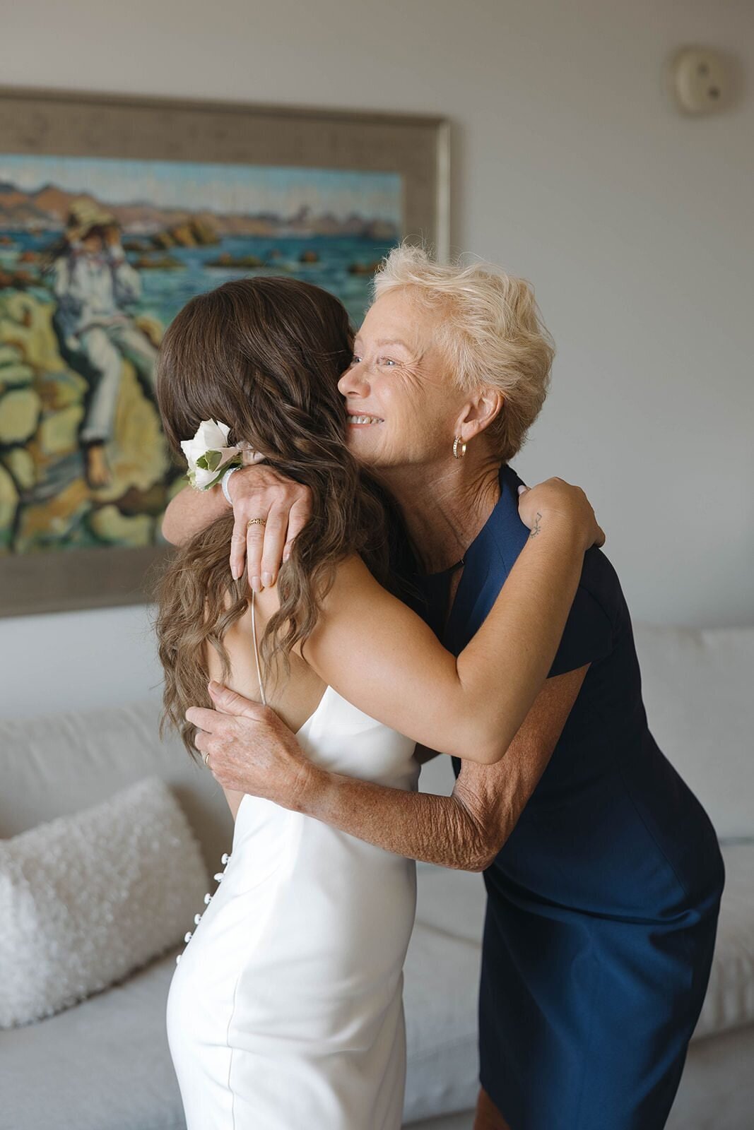 Bride hugging her mom after putting on her dress