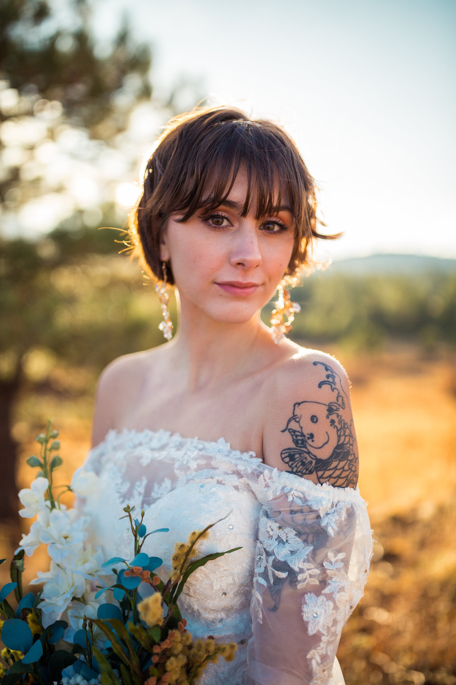 bride with tattoos and long sleeve wedding dress