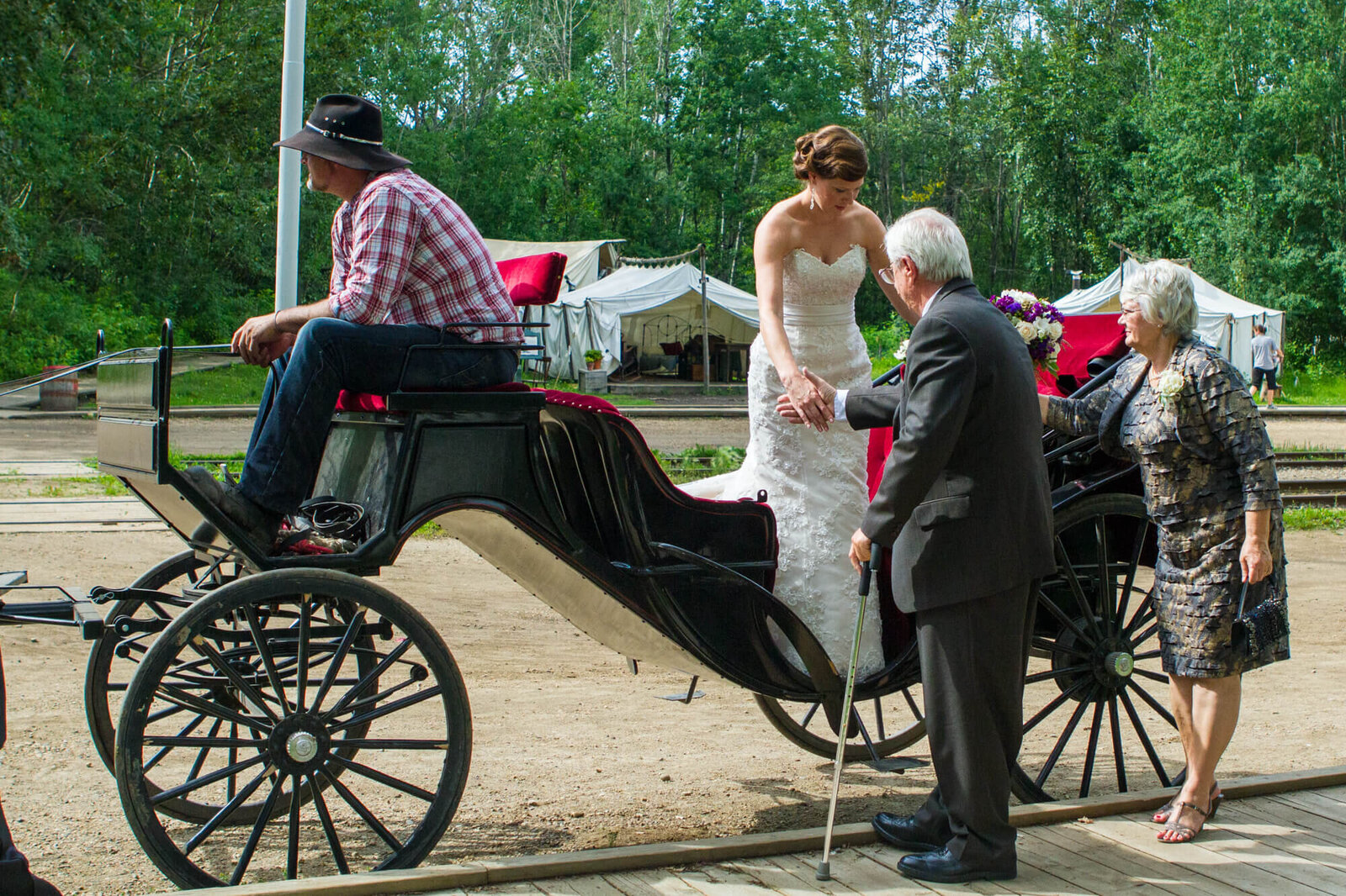Bride being helped off the Horse and Carriage at Fort Edmonton Park