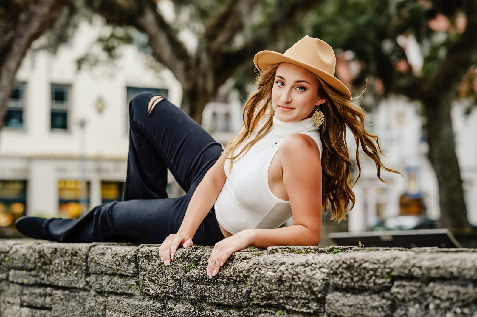 St. Augustine senior picture with wall and hat