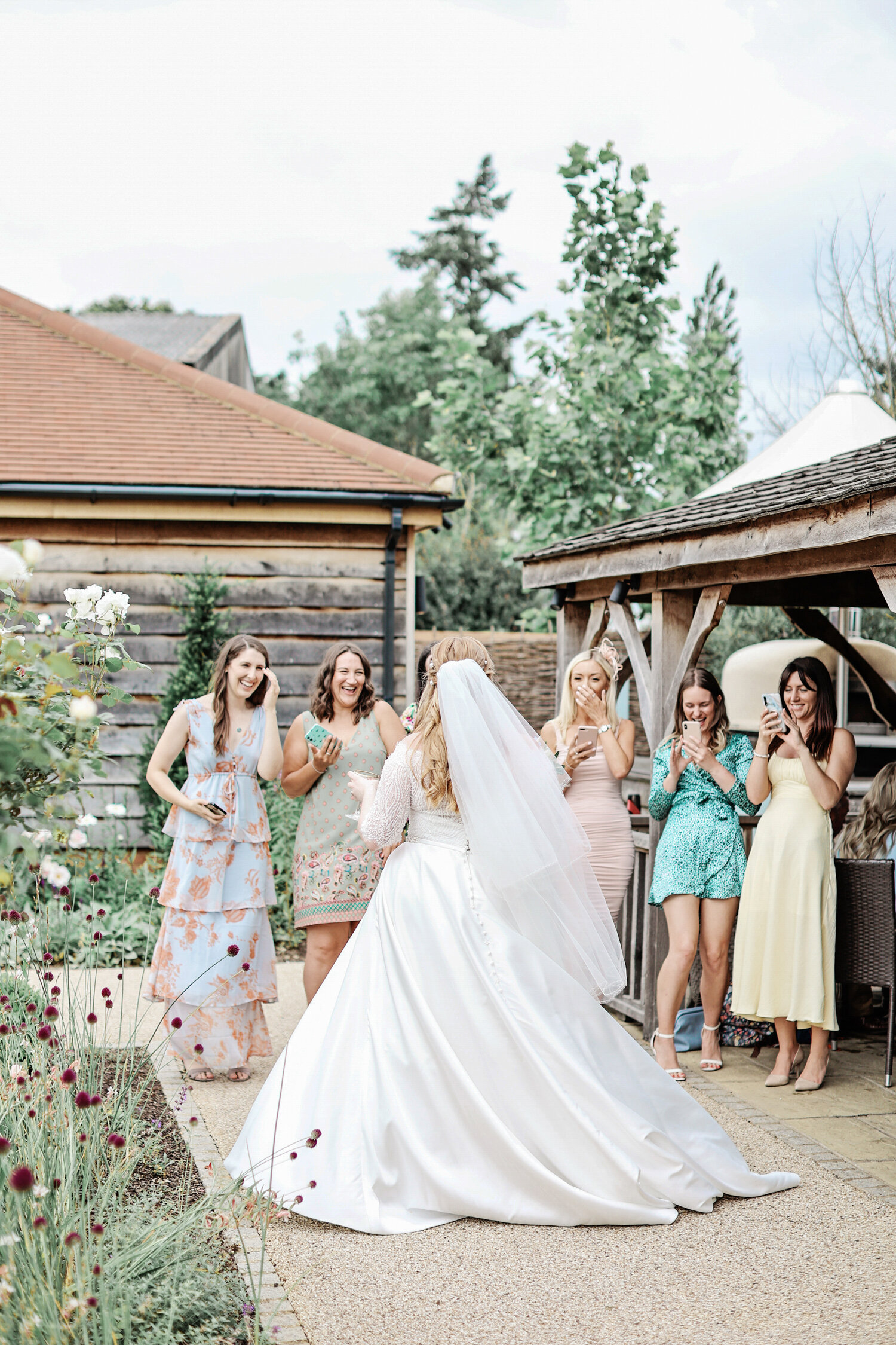Bassmead-Manor-Barns-wedding-bride-showing-off-dress