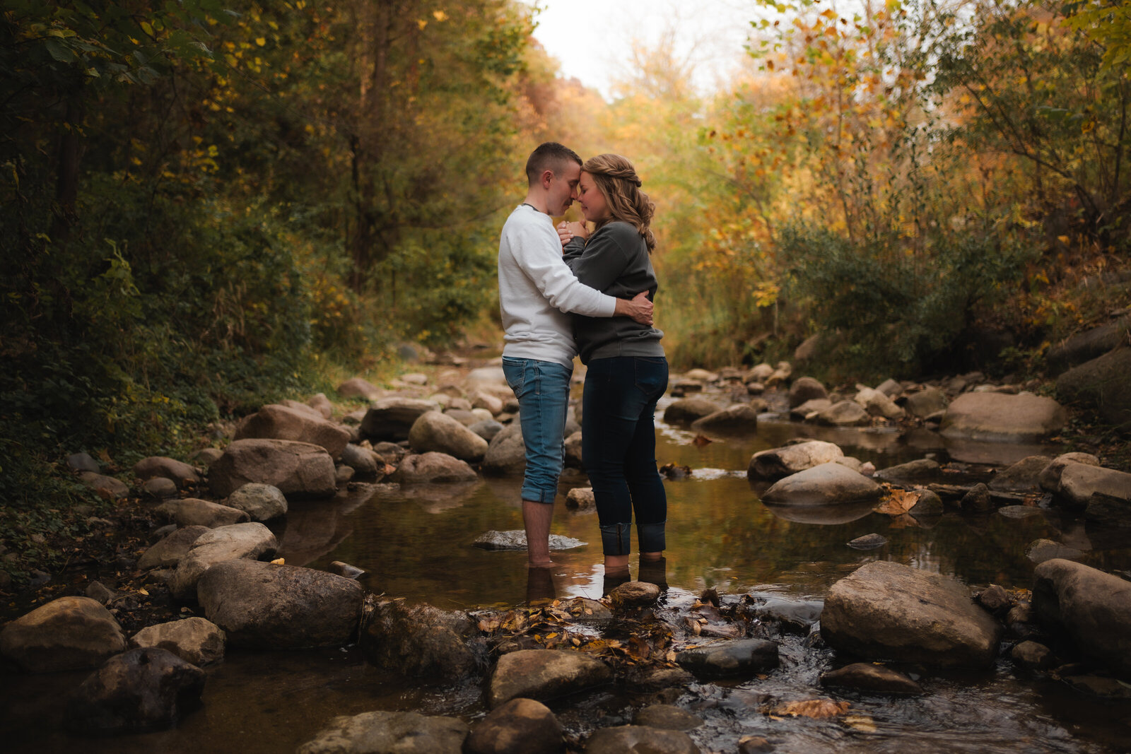 engagement photos of a couple standing in the water engagement photos standing in a stream ledges state park Des Moines Iowa
