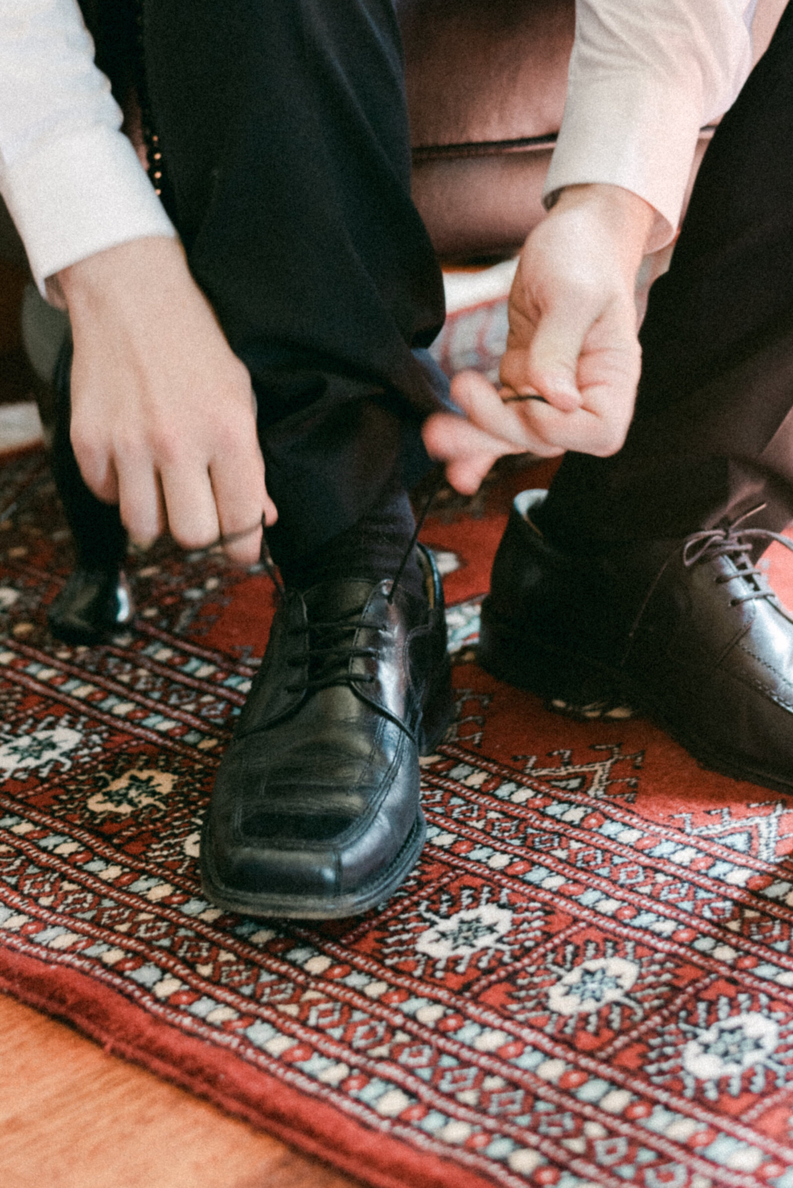 THe groom is tying his shoe laces in an image photographed by wedding photographer Hannika Gabrielsson.