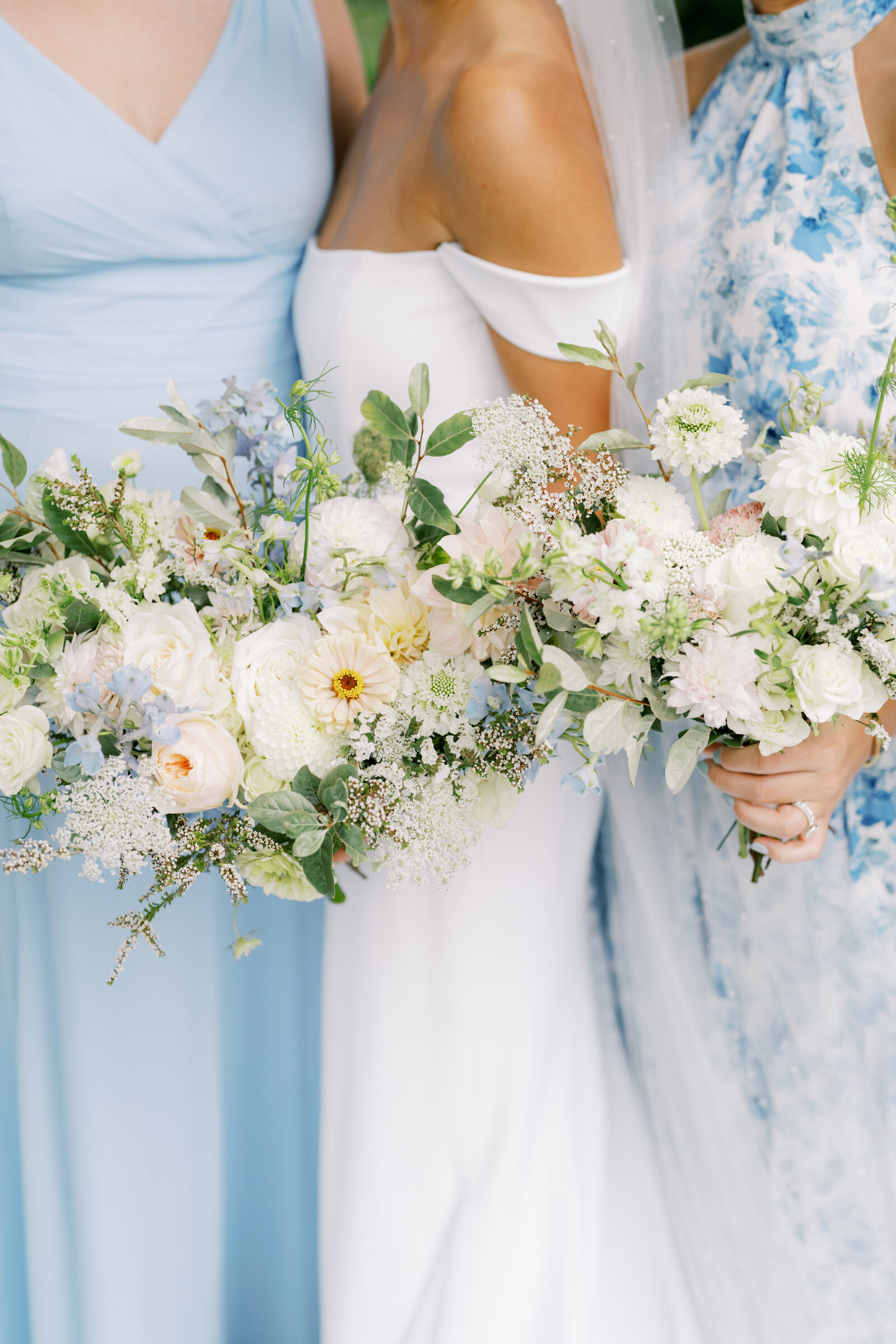 Bride and bridesmaids hold bouquets