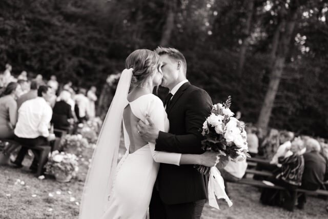 Bride and groom first kiss at wedding by elopement photographer in Washington