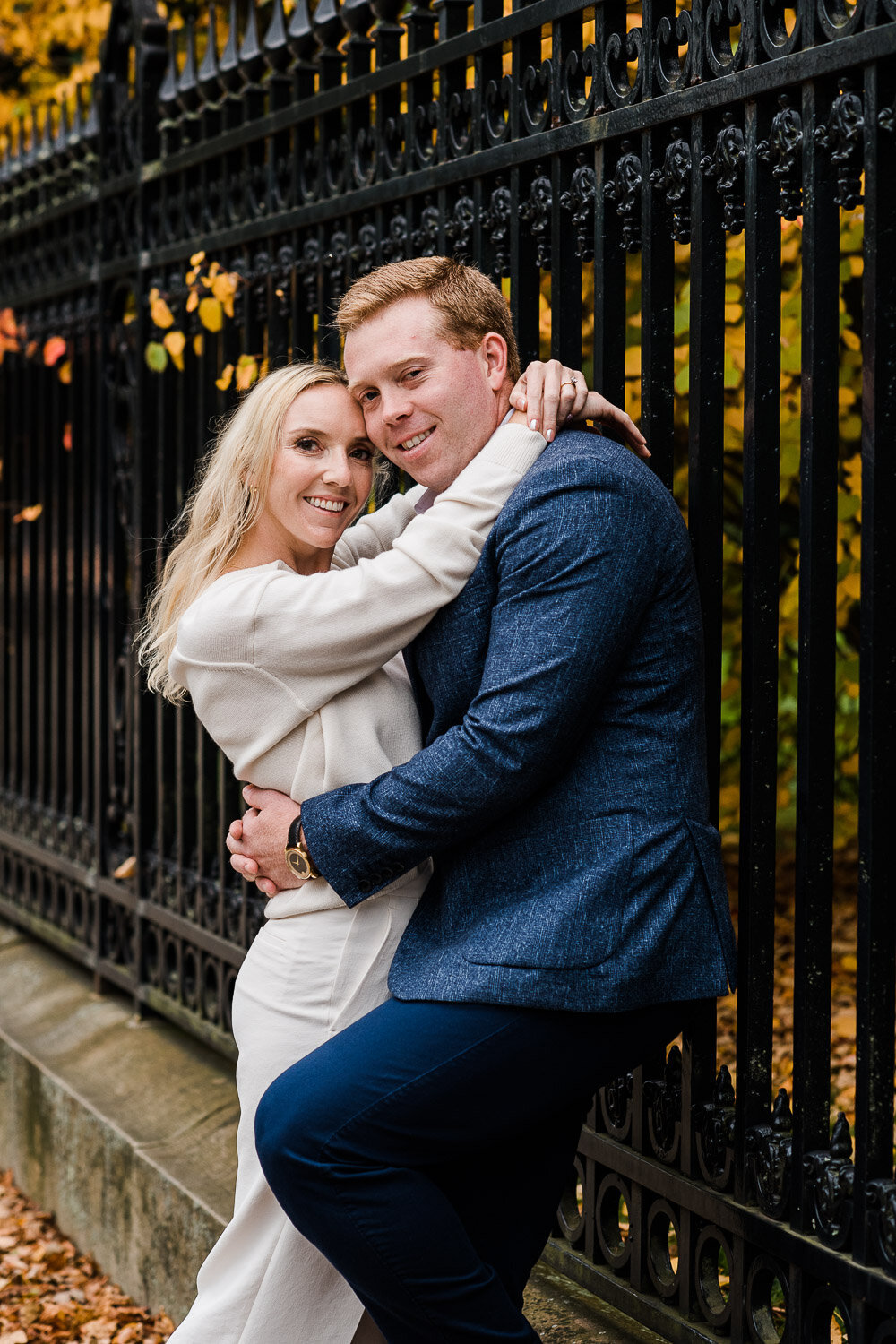 couple embrace by ornate gate