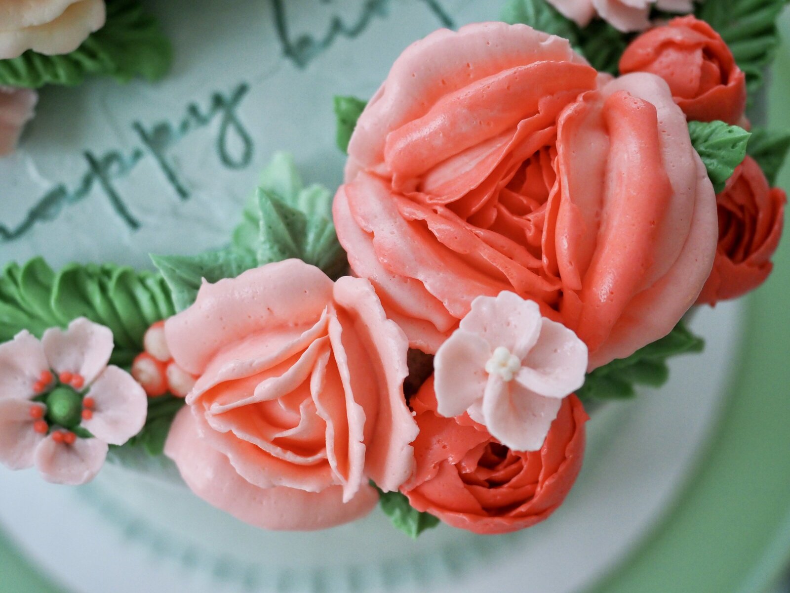 Close up of pink flowers on a buttercream flower cake