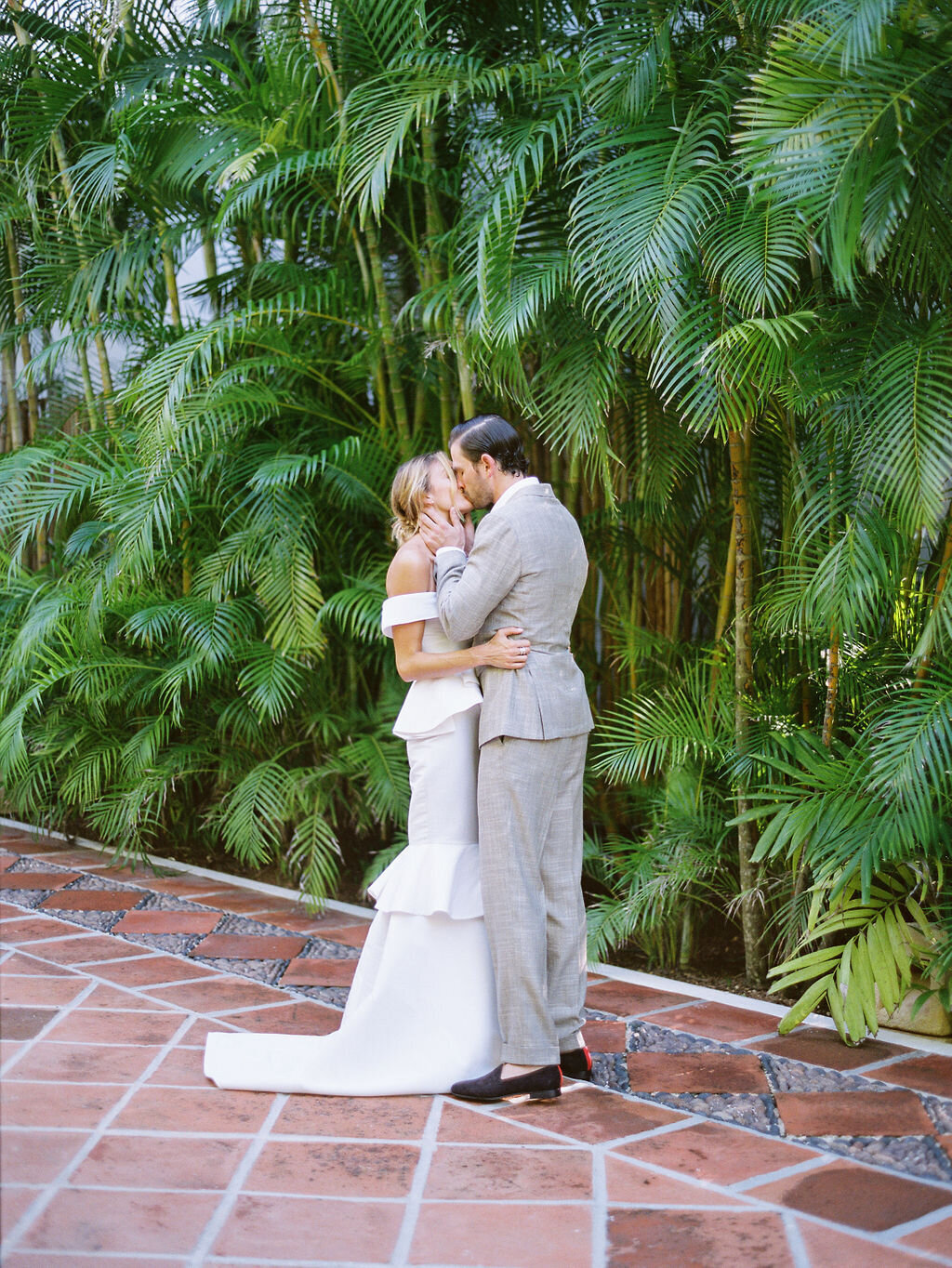 Couple kissing at destination wedding in Tulum Mexico