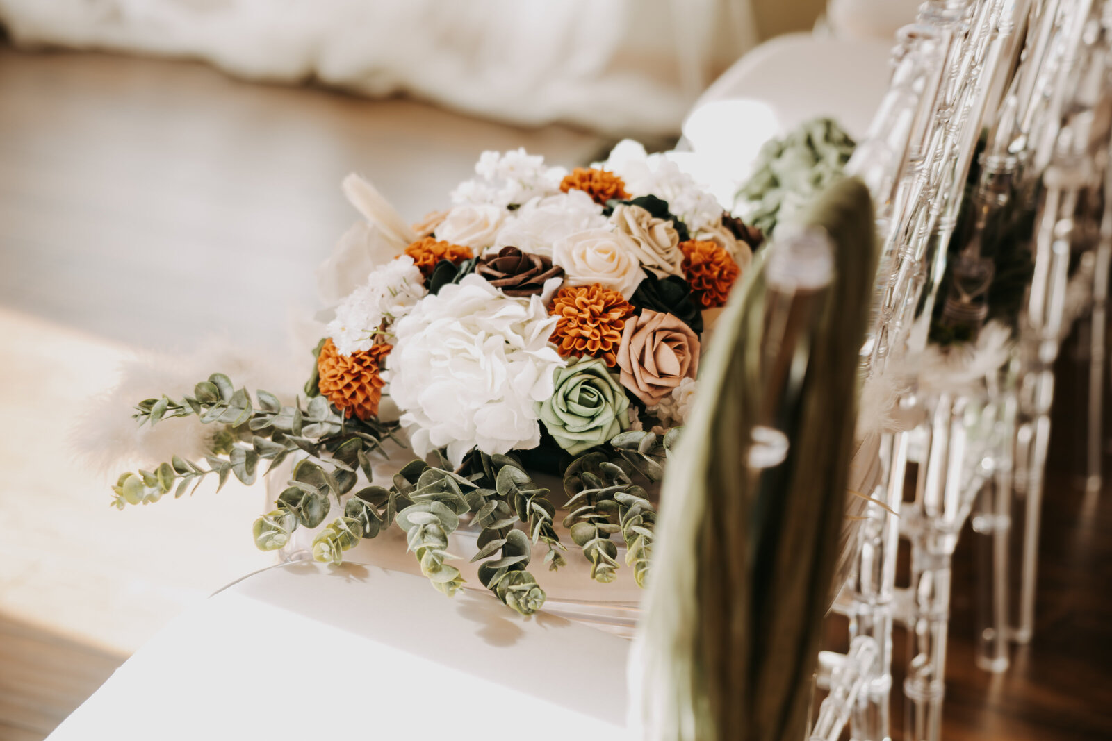 Bridal bouquet sitting on chairs in the ceremony room at Kincaid Manor, adding a touch of elegance to the setting.