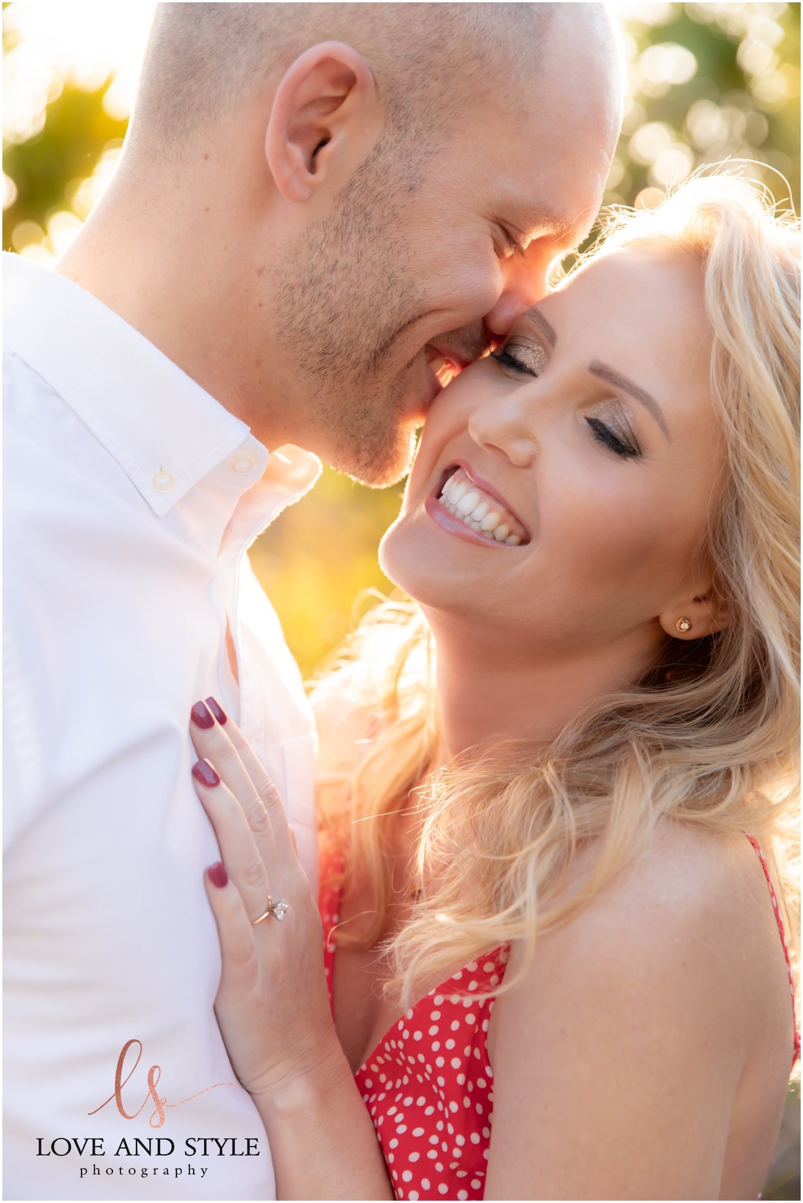 Engaged couple snuggling with ring visible