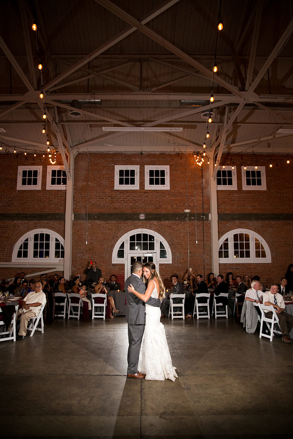 bride and groom at reception dancing at brick
