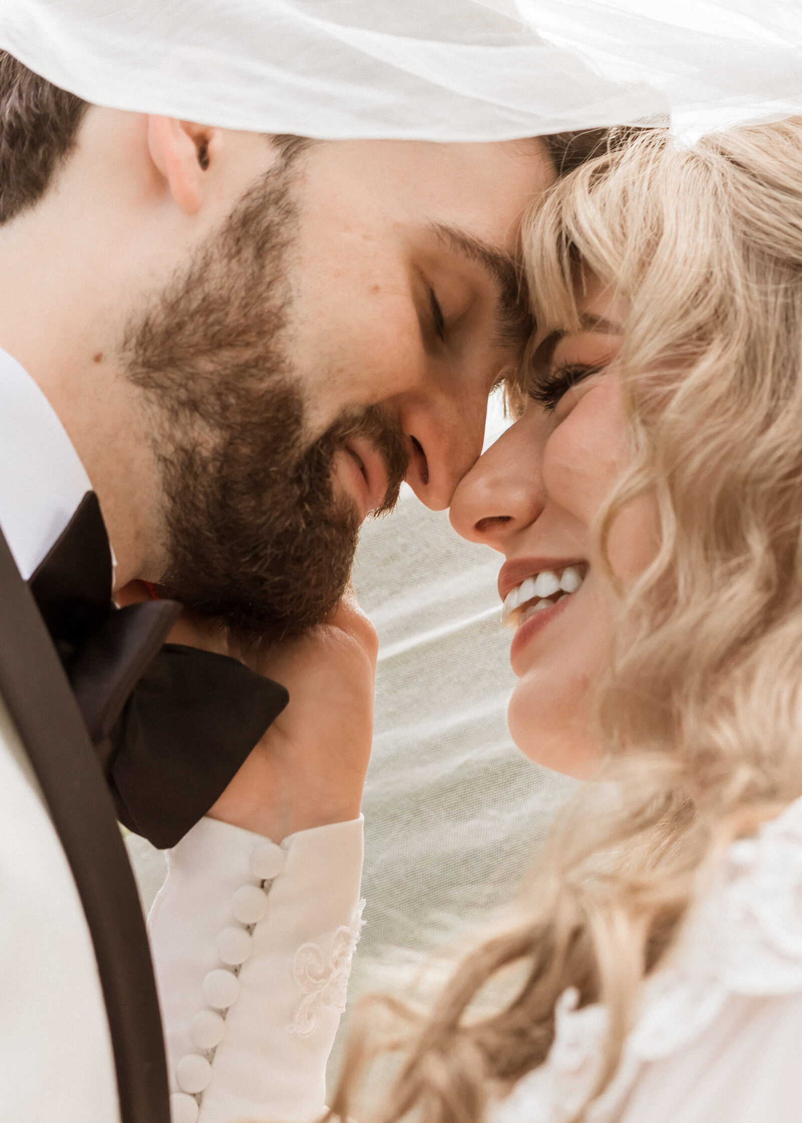 Couple kissing under brides veil at Camp Colton in Colton, Oregon