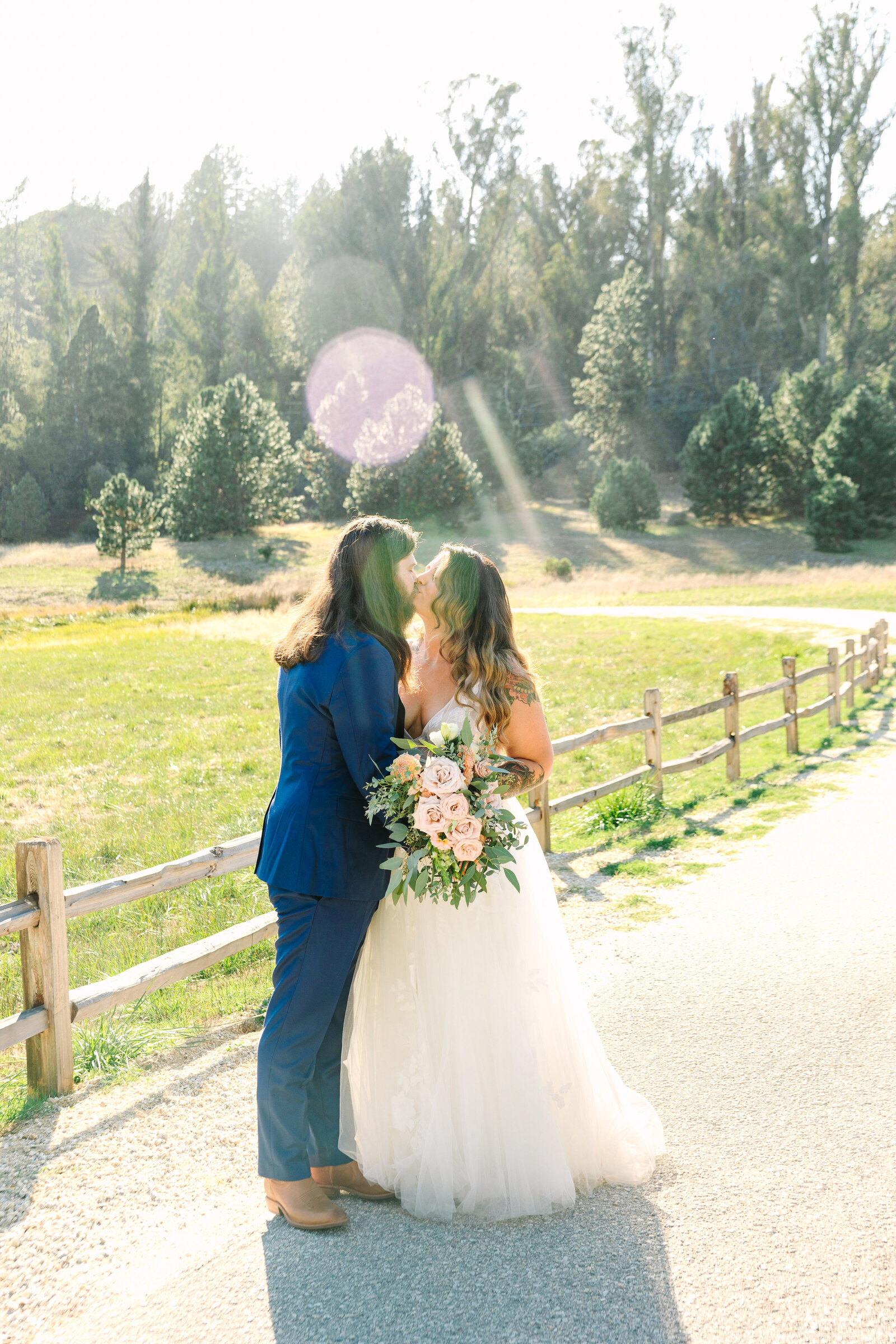 Tattoo bride and groom embrace on their colorful wedding day in Santa Cruz, California.