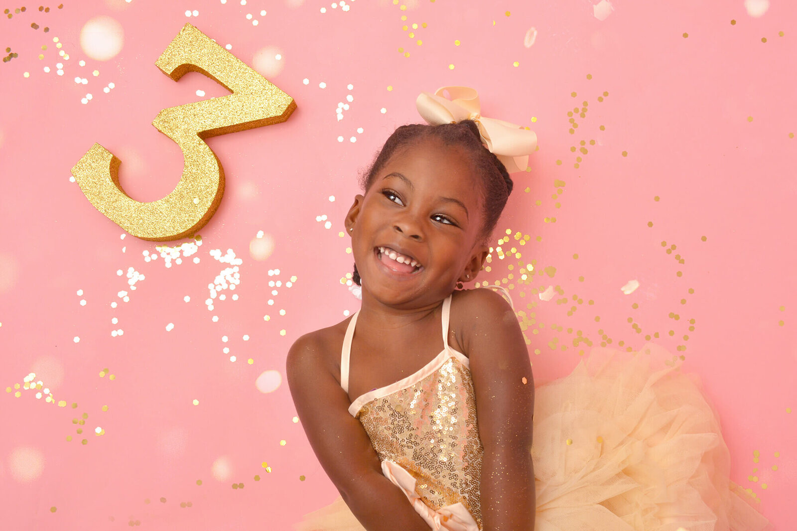girl smiles at her 3rd birthday glitter photoshoot