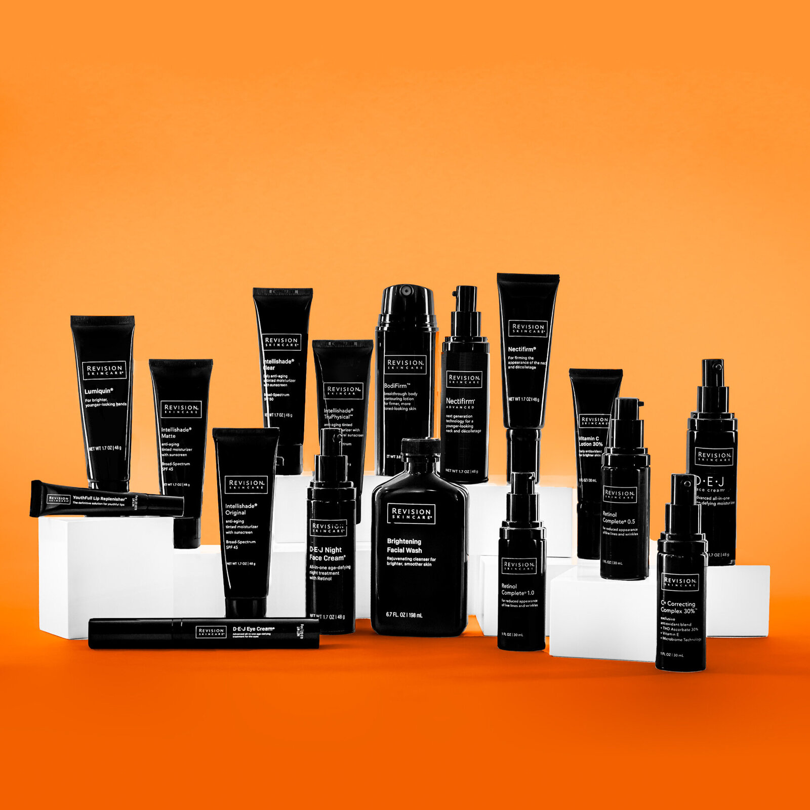 Full product line for Revision Skincare on orange background