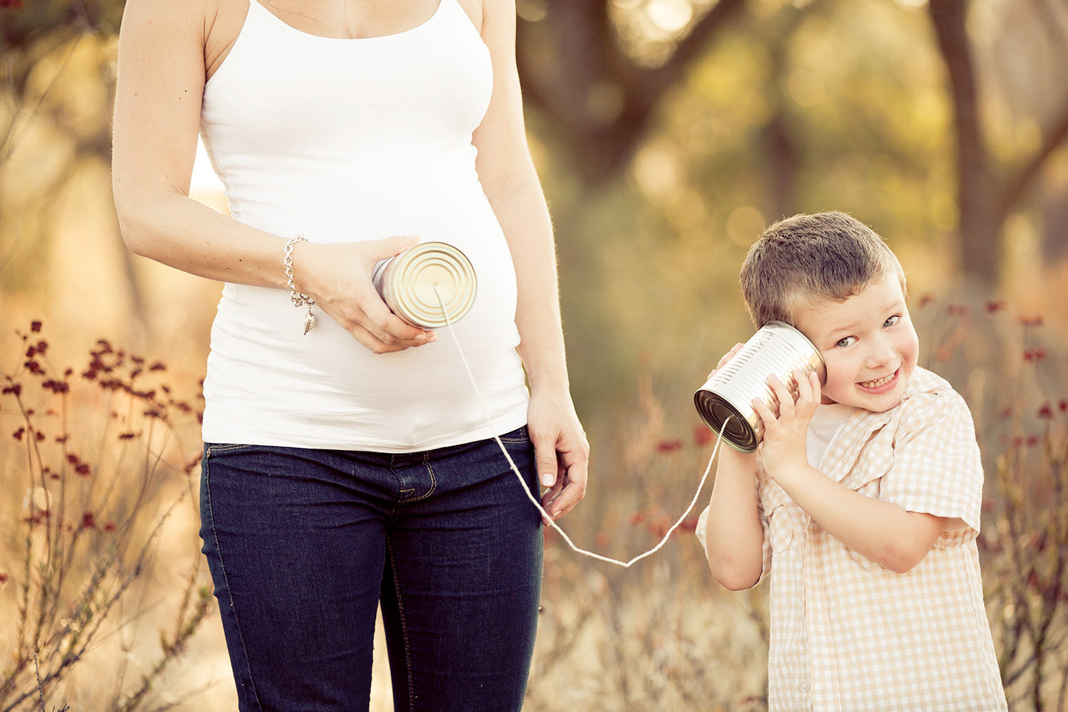 Adorable old telephone can on a string Maternity photo in San Diego.