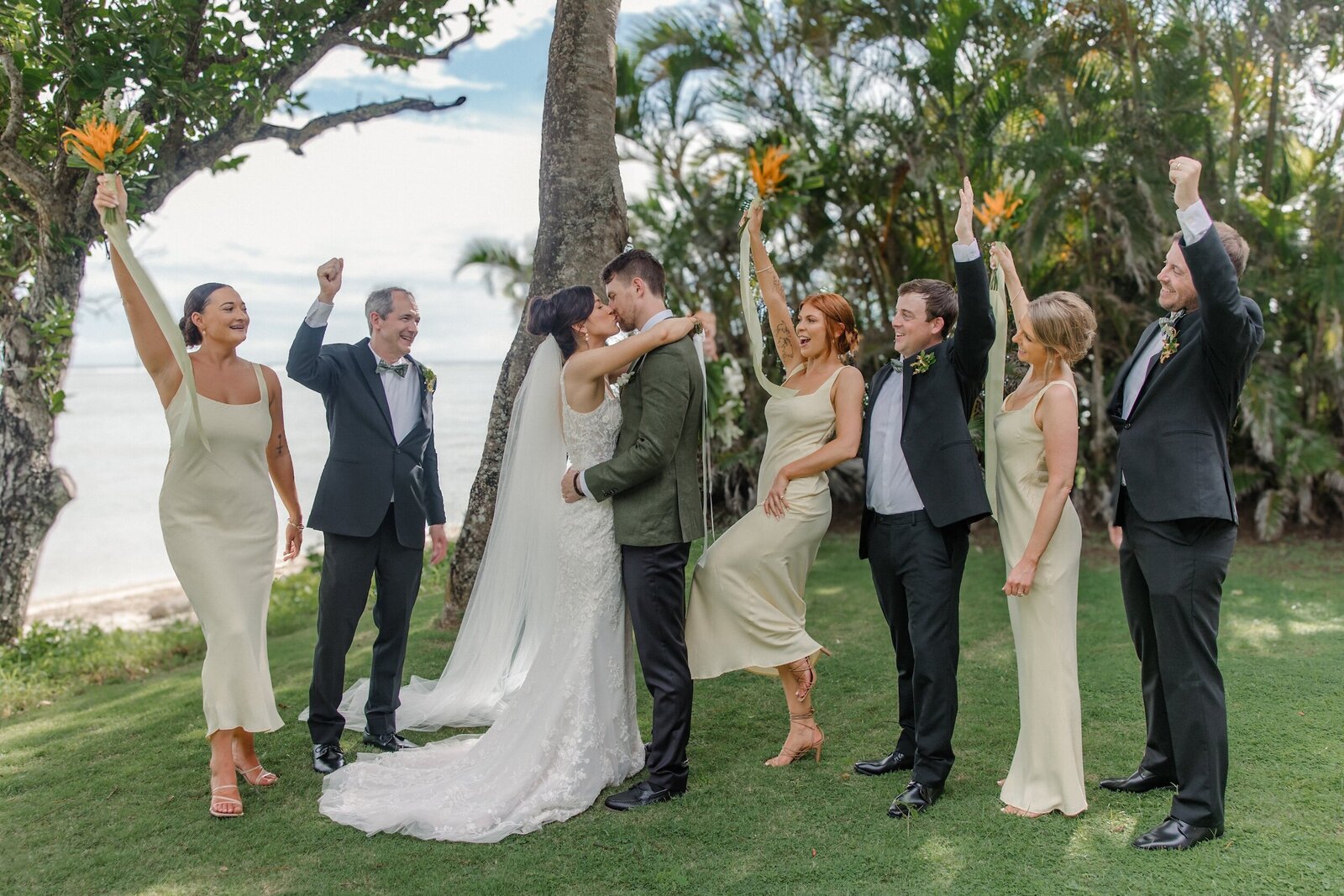 Bride and groom with bridal party cheering