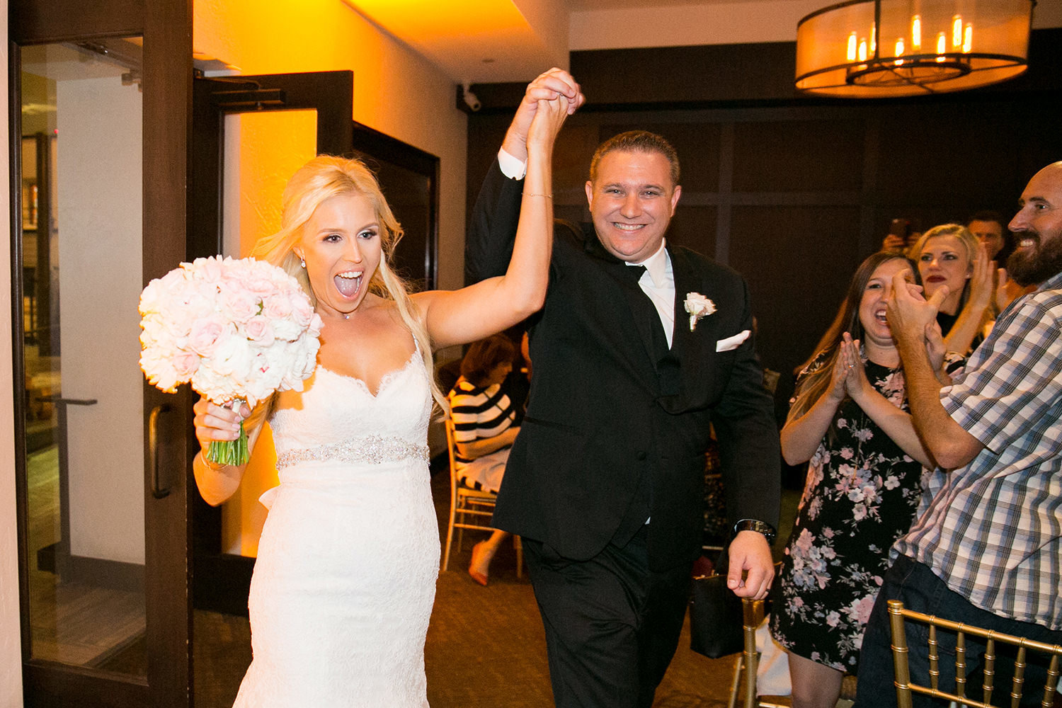 bride and groom walking in the reception