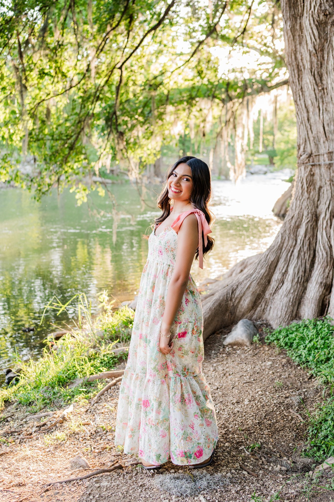San Antonio high school senior posing by the water in Gruene 
