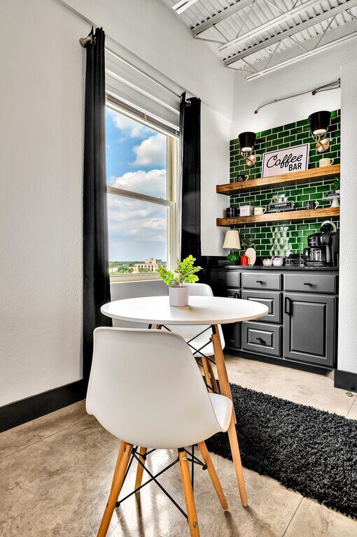 Breakfast nook for two with a city view from this one-bedroom, one-bathroom vacation rental condo with sleeping space for four is walking distance from the Silos, McLane Stadium, and Baylor University in downtown Waco, TX