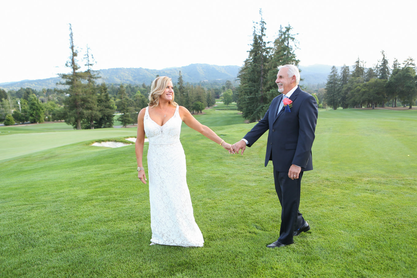 Bride and groom walk on golf course in northern california. Beautiful country club wedding