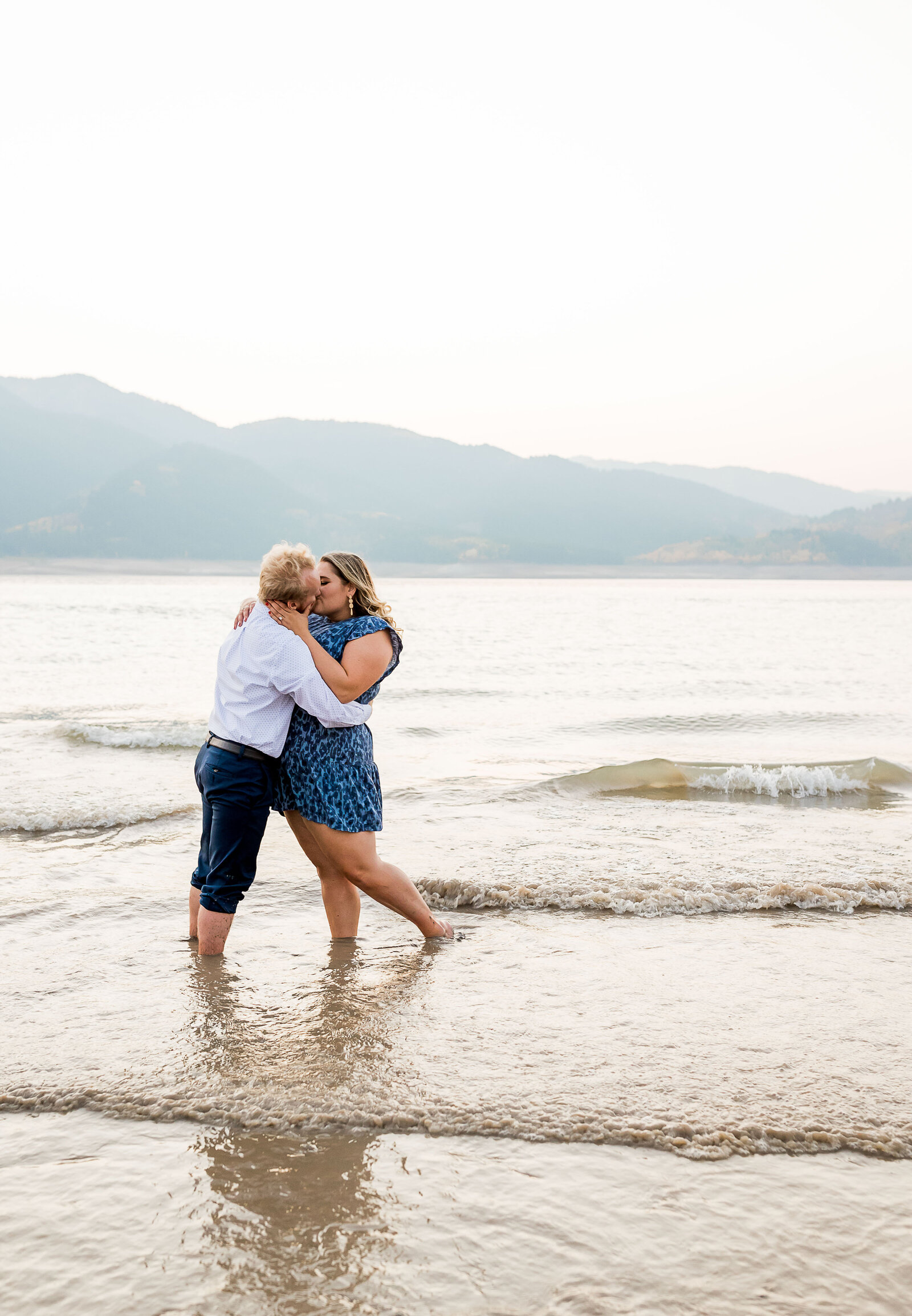 engaged couple walks out to the lake at Palisades, Reservoir near Jackson, Wyoming taken by Utah Wedding Photographer Robin Kunzler