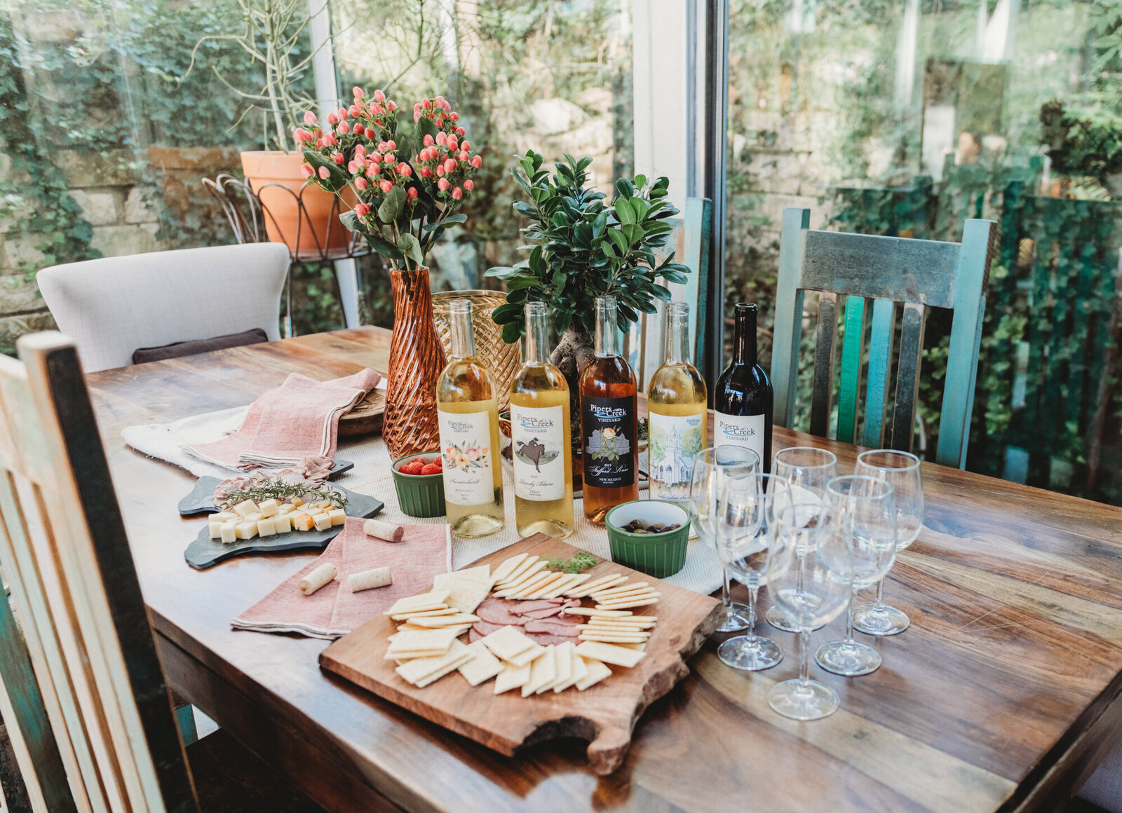 Branding Photographer, a table is set with a charcuterie in the center, lush garden outside the windows