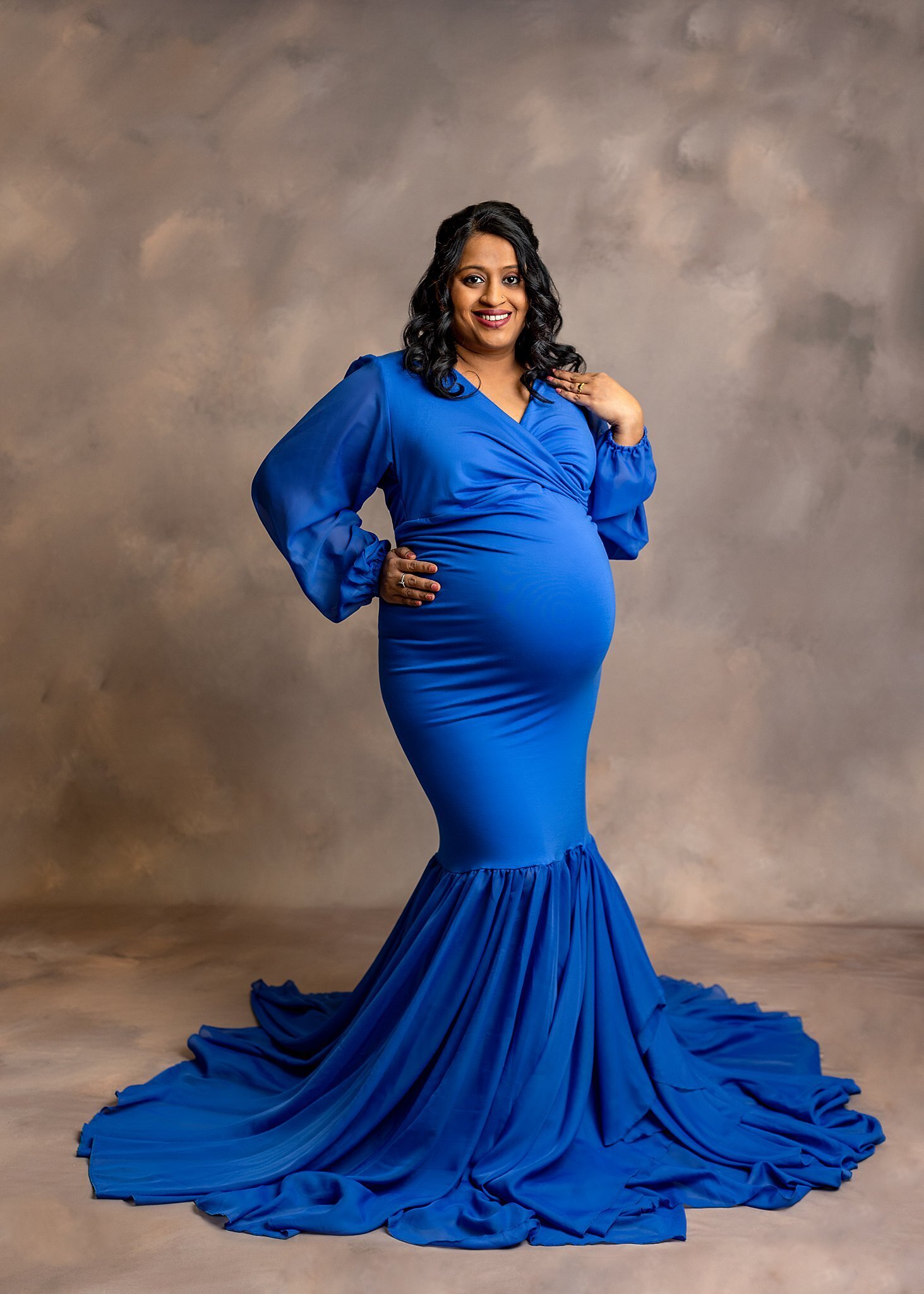 Pregnant mom wearing a blue dress.