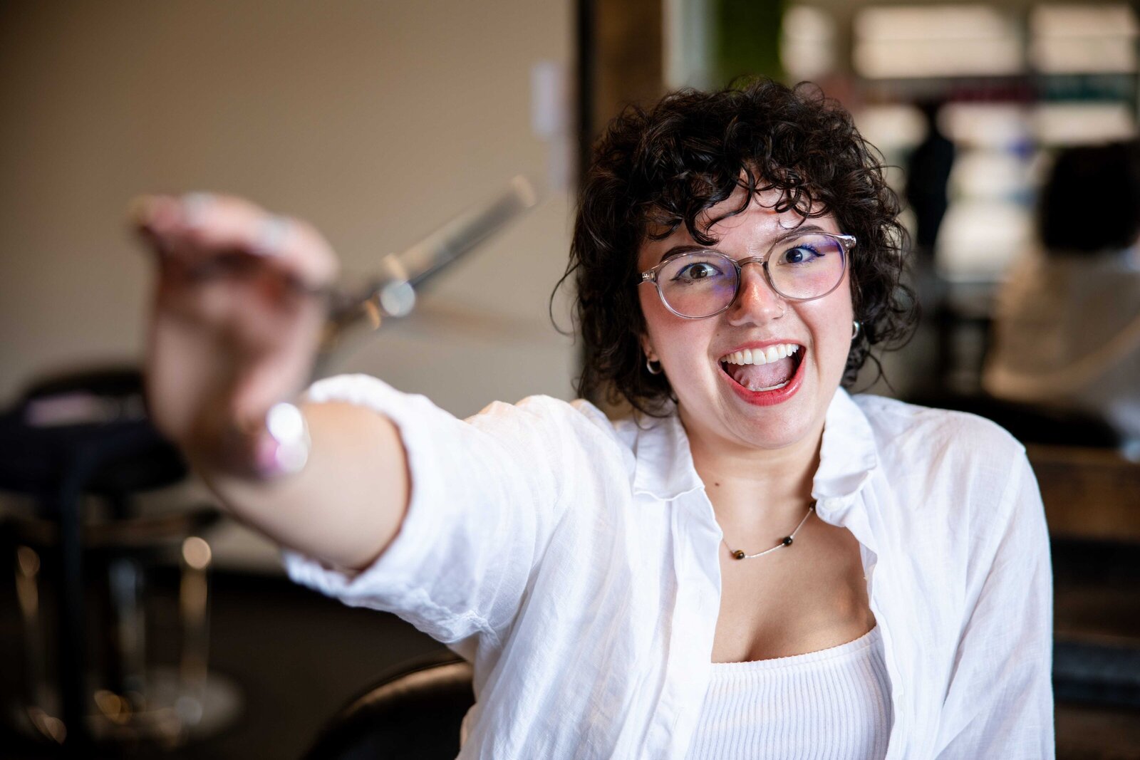 Professional stylist holding a pair of scissors during personal branding photography session