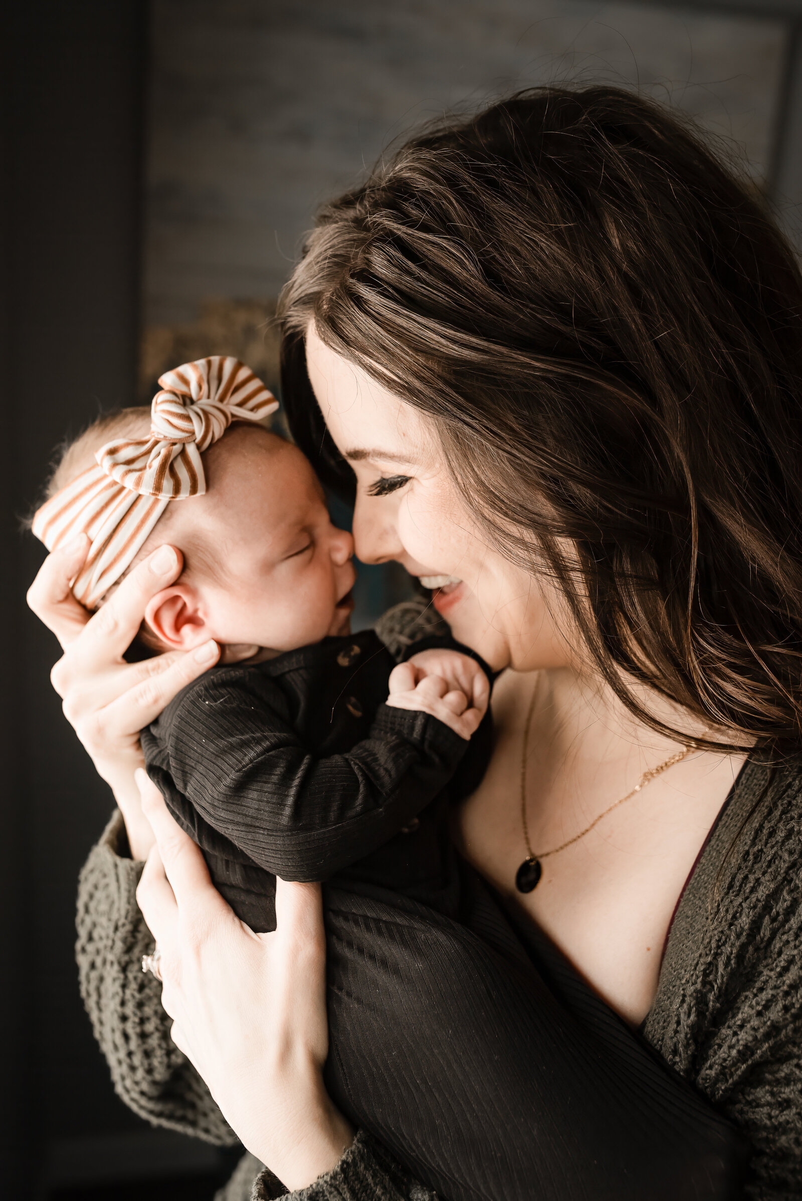 A mom holds so tight to her new baby and new best friends during an in-home newborn session in Washburn, ND