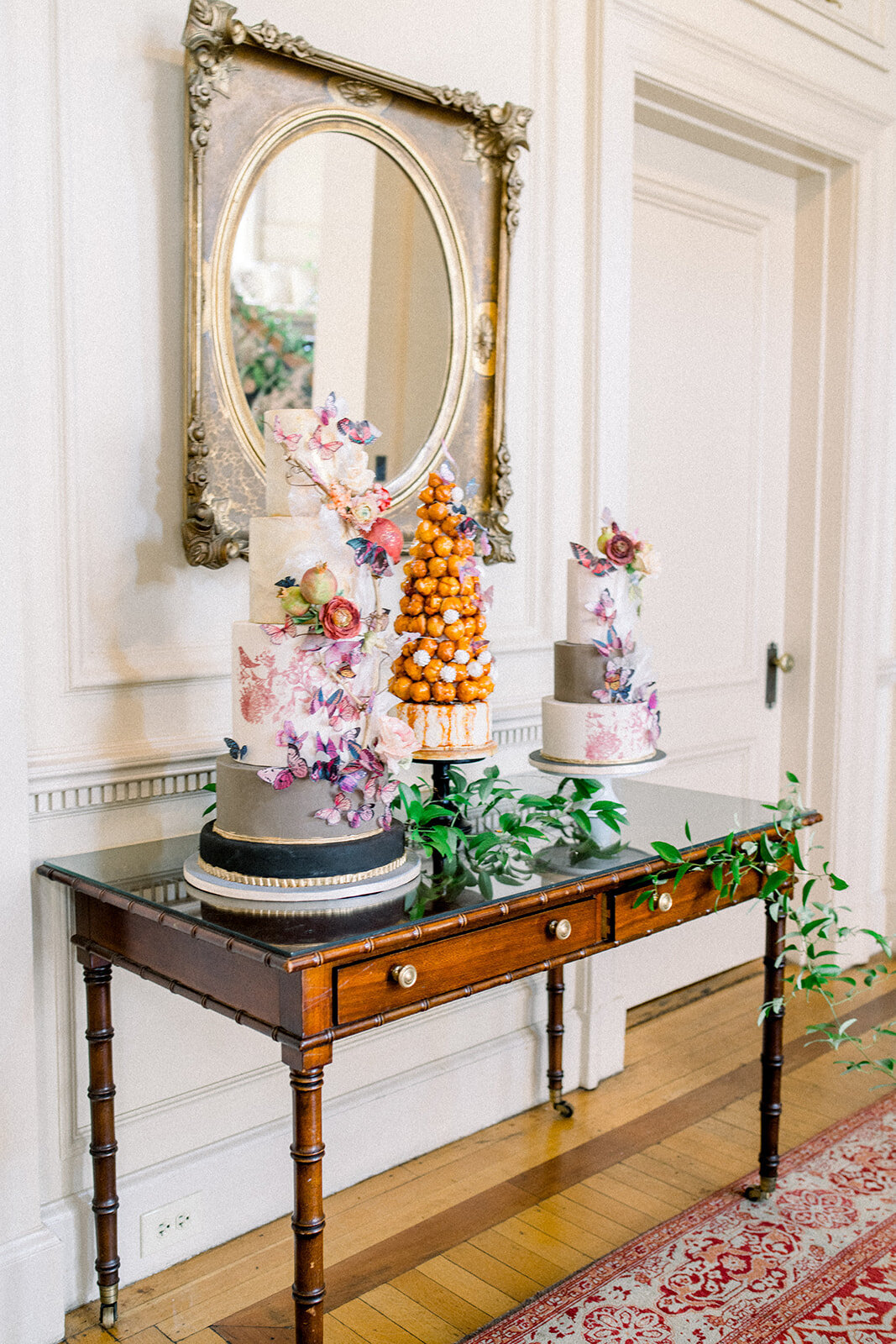 An exquisite display of the wedding cake and desserts, highlighting the elegance of the wedding reception at Filoli in Woodside, California.