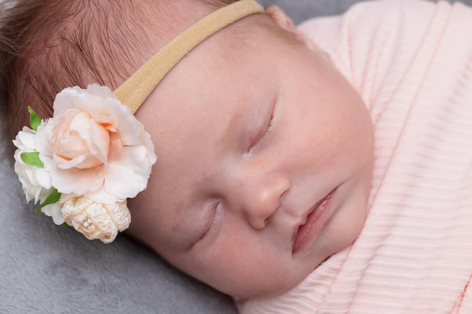 A close-up of a baby girl sleeping.