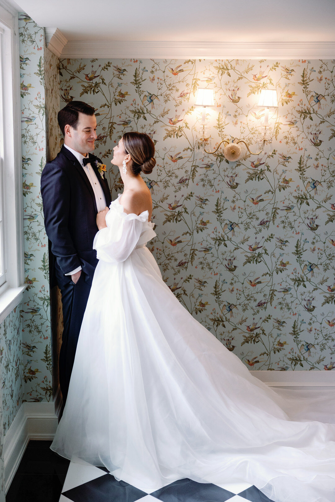 bride and groom smiling at each other in Hall at The Carolina Inn