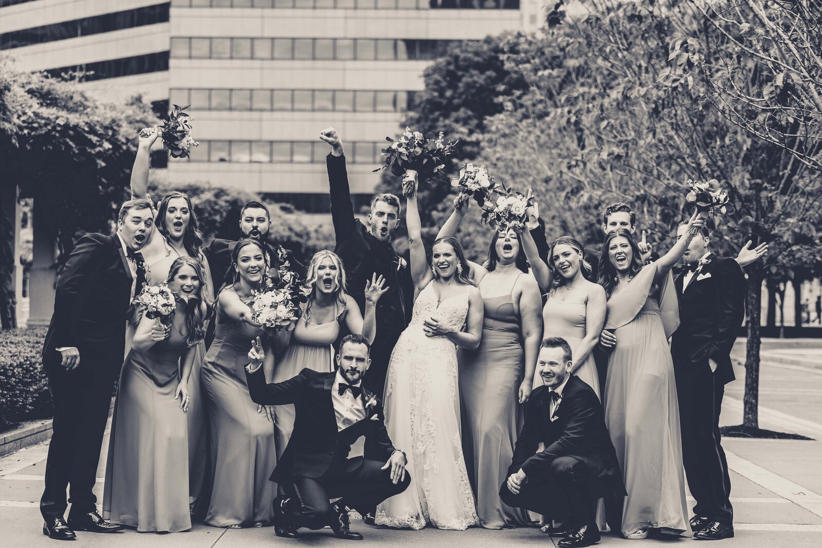 Celebrate the dynamic energy and vibrant spirit of Sandy and Jack’s bridal party with this incredible shot captured at P&G Gardens. The image features the entire group in a moment of pure joy and celebration, surrounded by the lush backdrop of the gardens. Perfect for couples seeking lively and colorful wedding photography, this photo captures the essence of a fun and unforgettable wedding day, showcasing how each member adds to the celebration’s excitement and style.