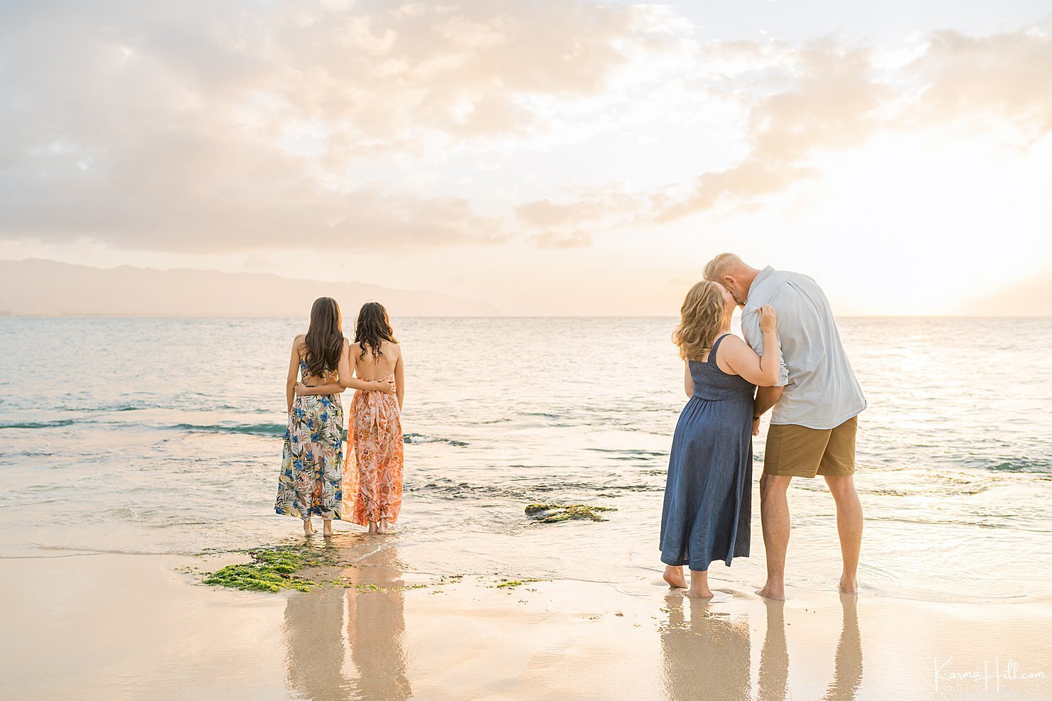 Family of four during their Oahu family portrait session on the beach.