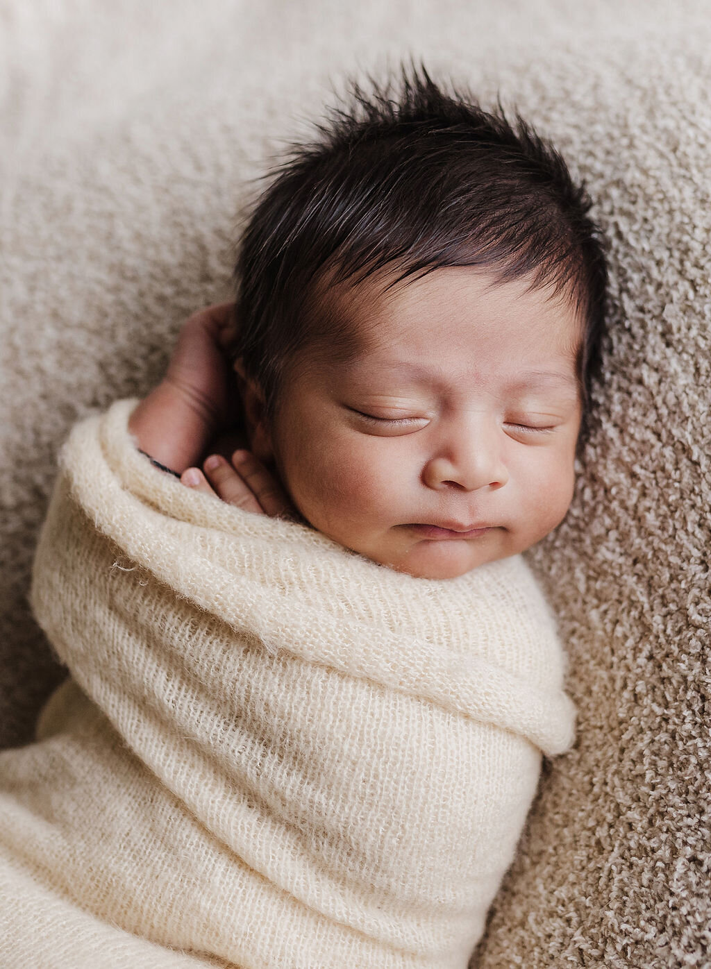 newborn photo on tan blanket