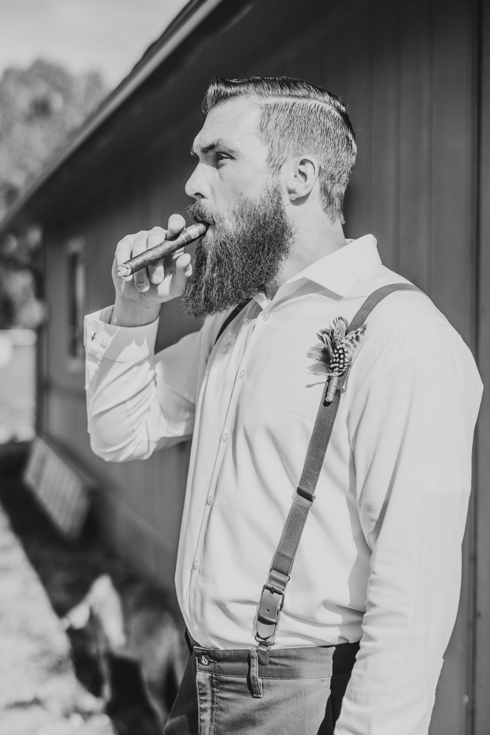 groom smoking cigar before wedding