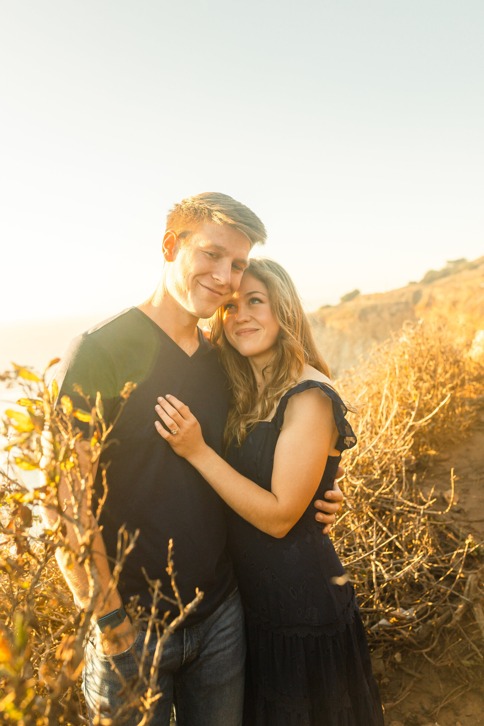 A couple poses for their engagement photos in Big Sur, California.