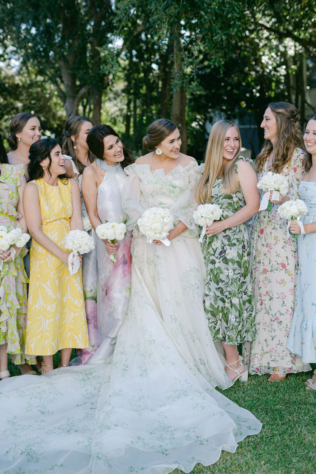 bride with bridesmaids in floral patterned dresses for a beach wedding in Florida