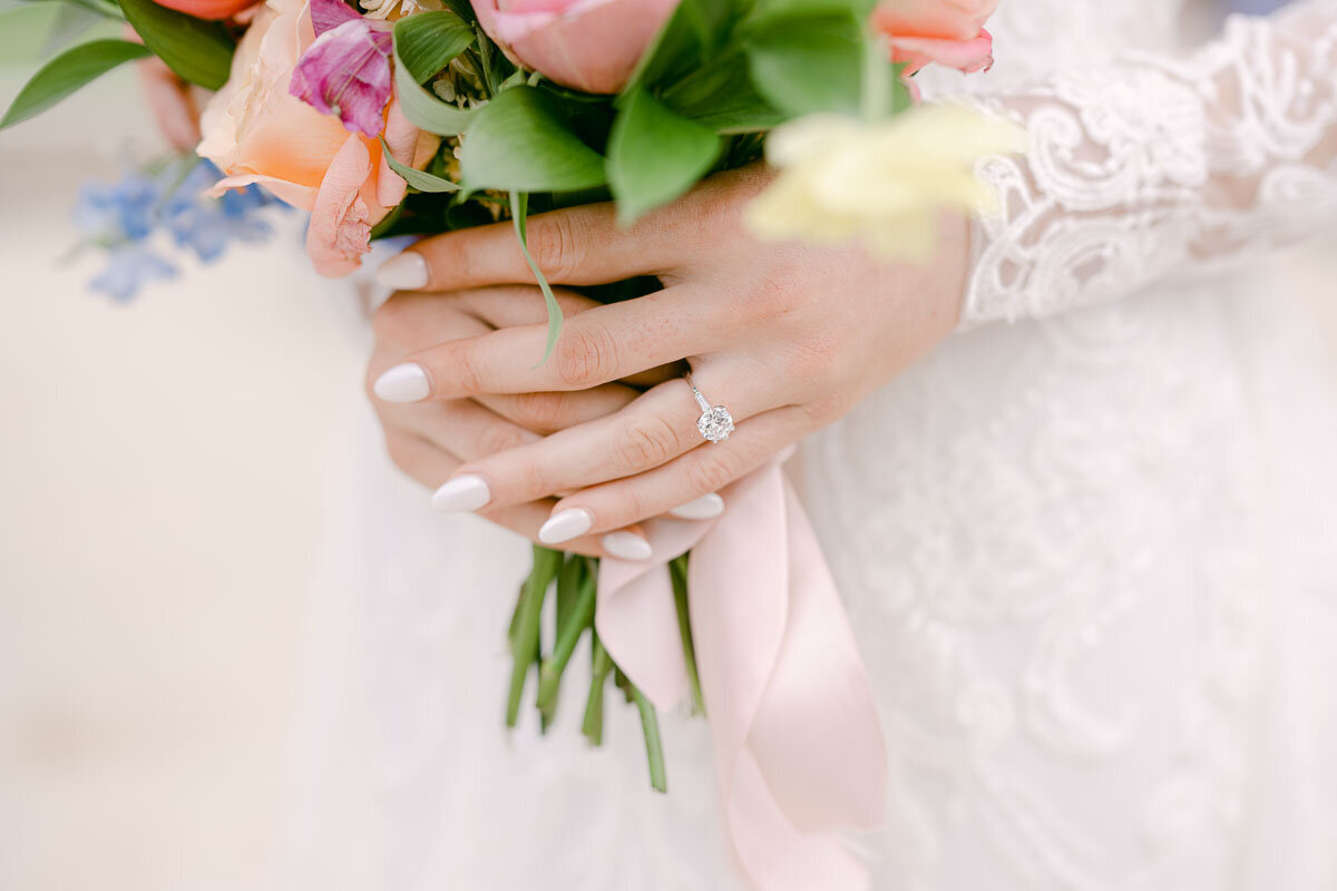 close up photo of bride holding bouquet to show off wedding ring