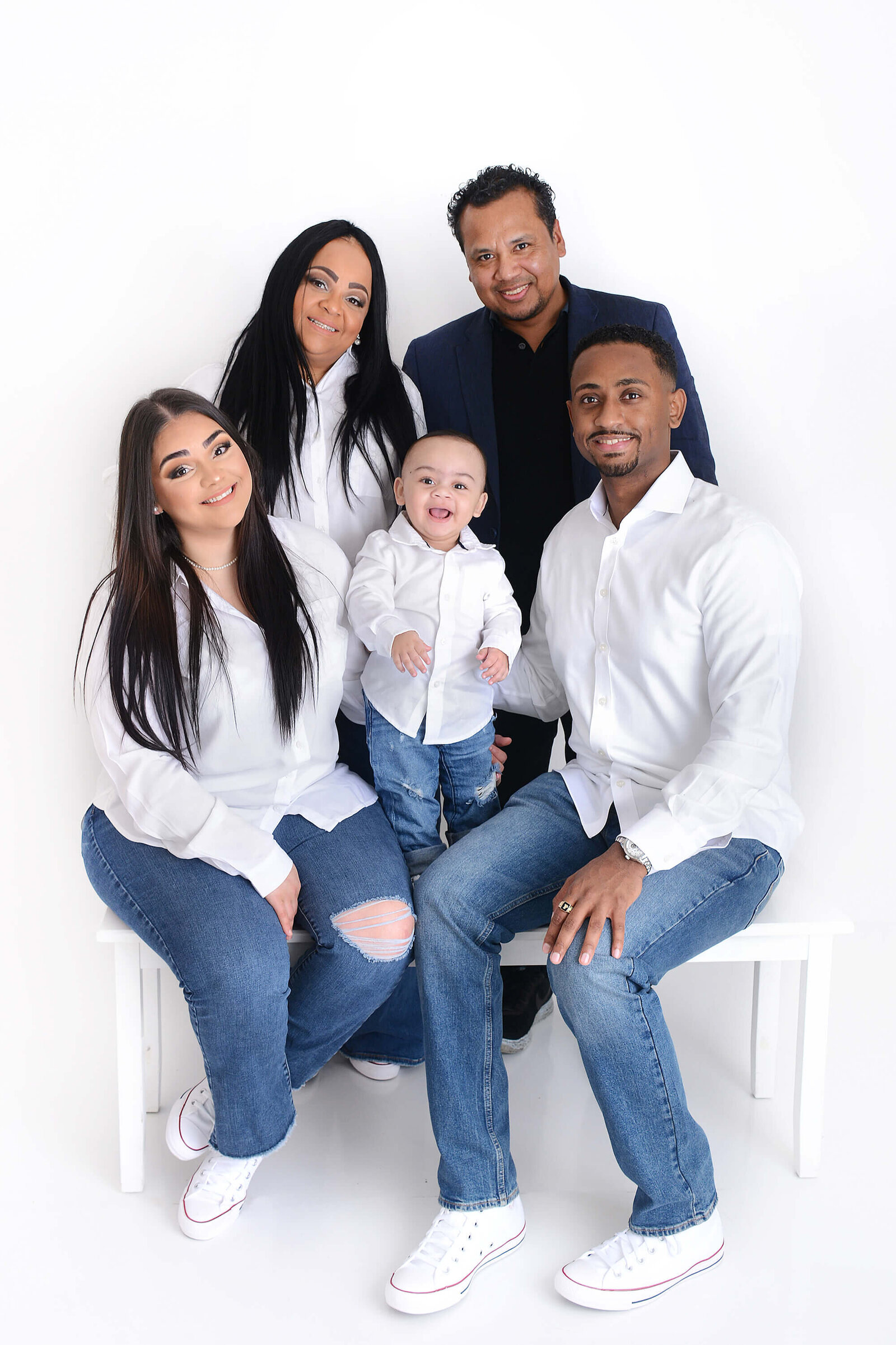 extended family photoshoot all wearing white at a photography studio in houston