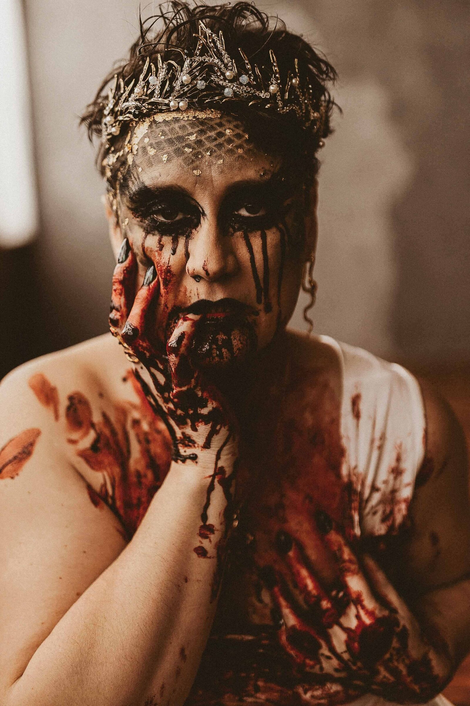 vampire make up woman with blood stains on hands