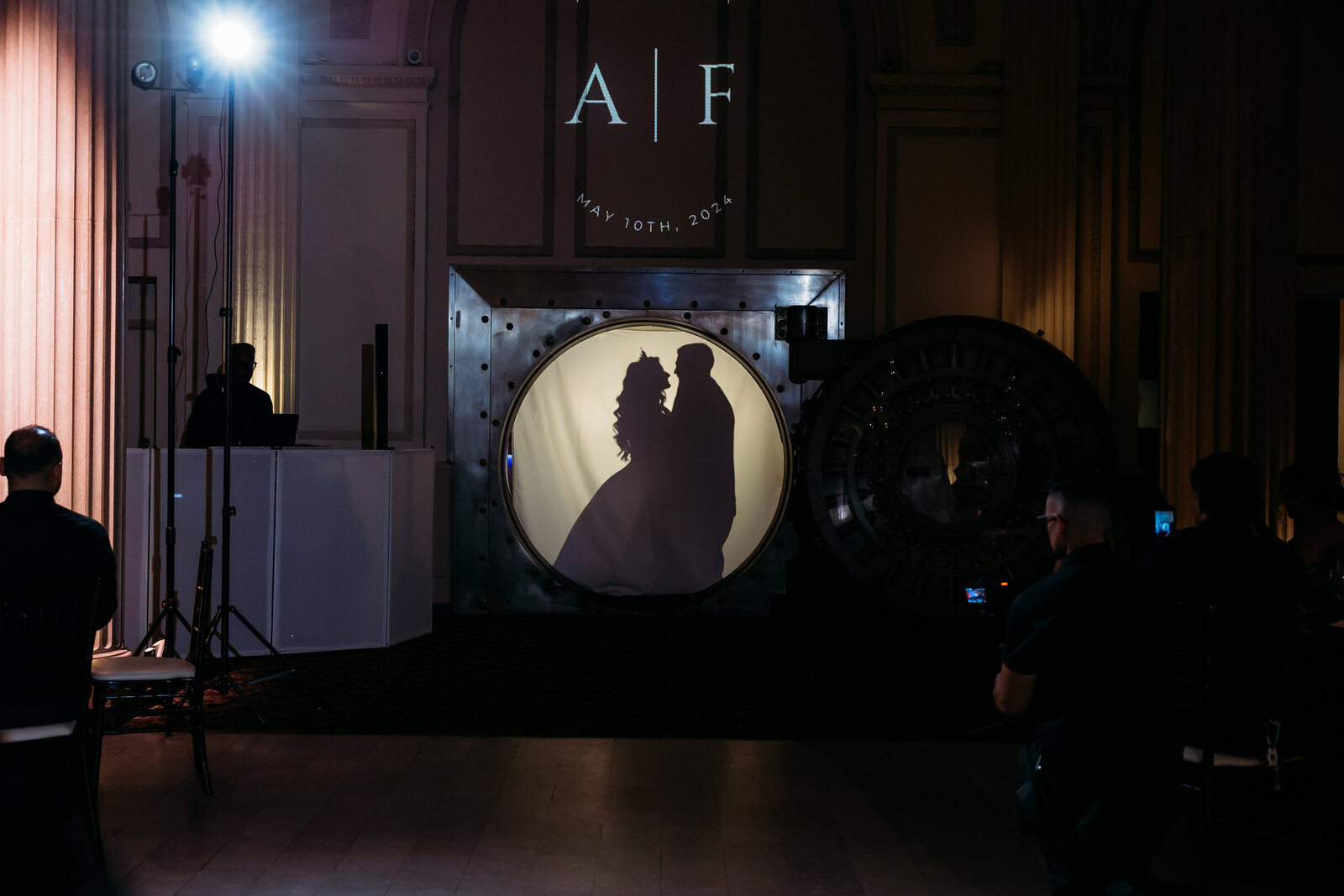 Couple’s silhouette projected inside the vault during their first dance at Treasury on the Plaza wedding in St. Augustine.