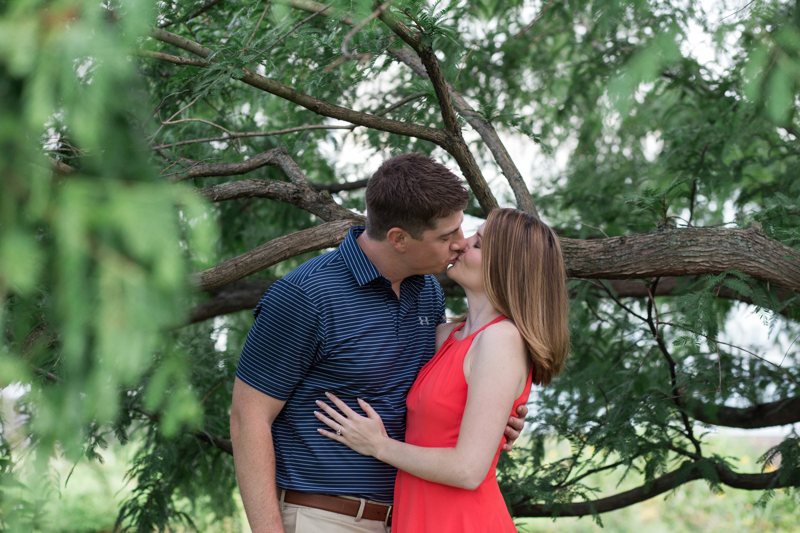 engaged_couple_kisses_under_tree_schenley_park