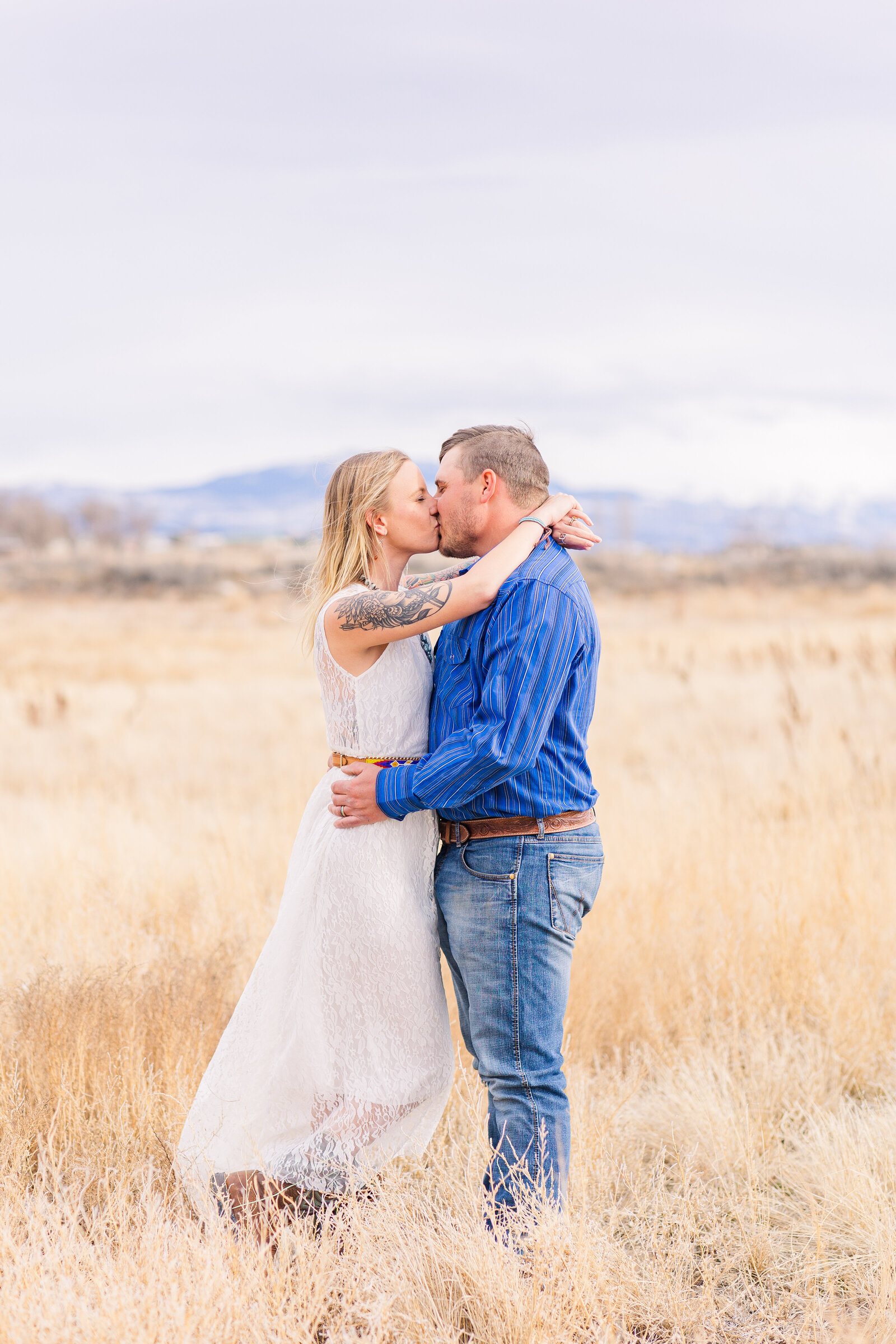 portrait of couple kissing in the field