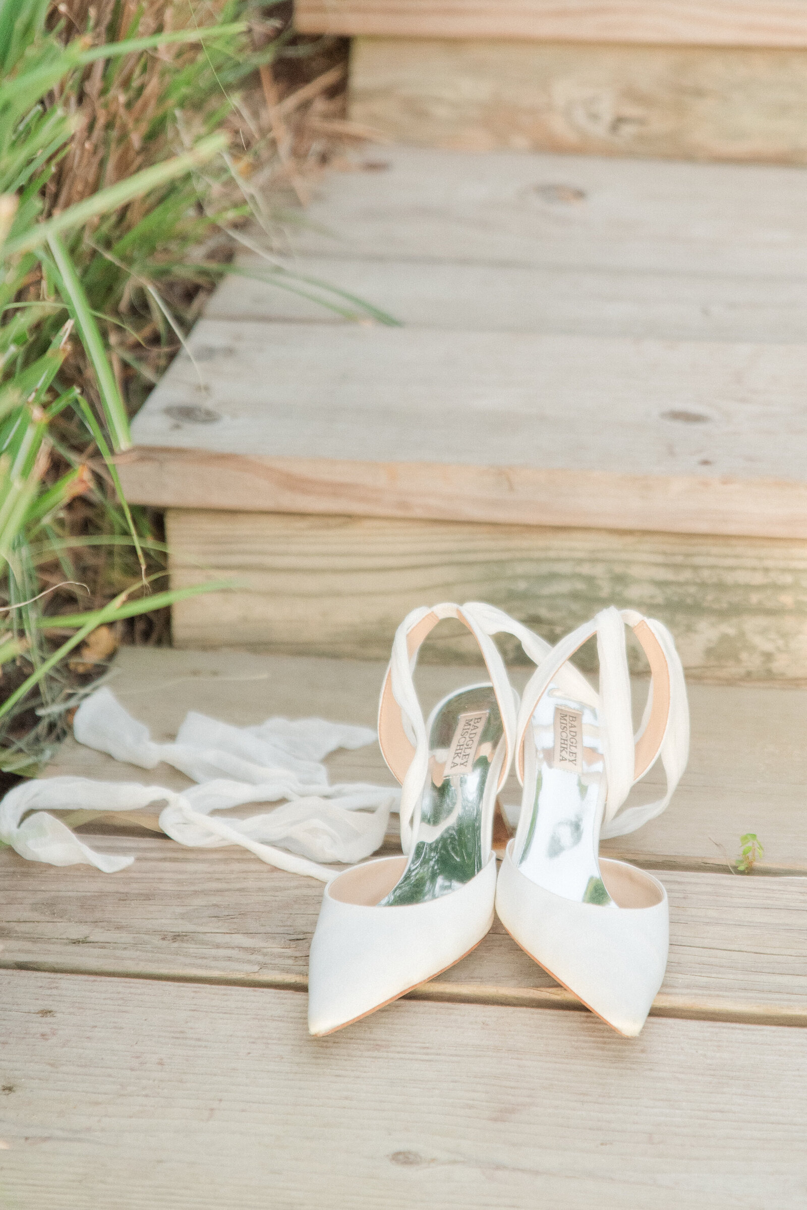 badgley mischka shoes on beach boardwalk