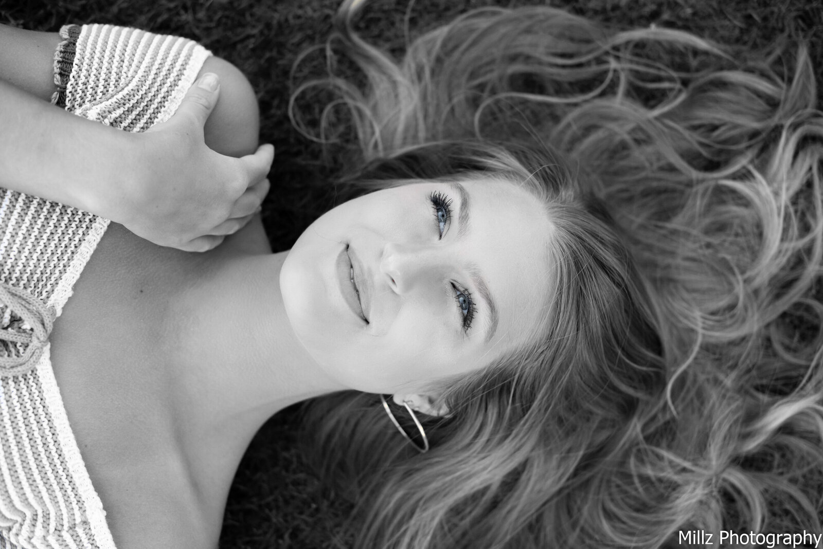 black and white photo of a girl laying on the ground looking up at the sky photographed by Millz Photography in Greenville, SC
