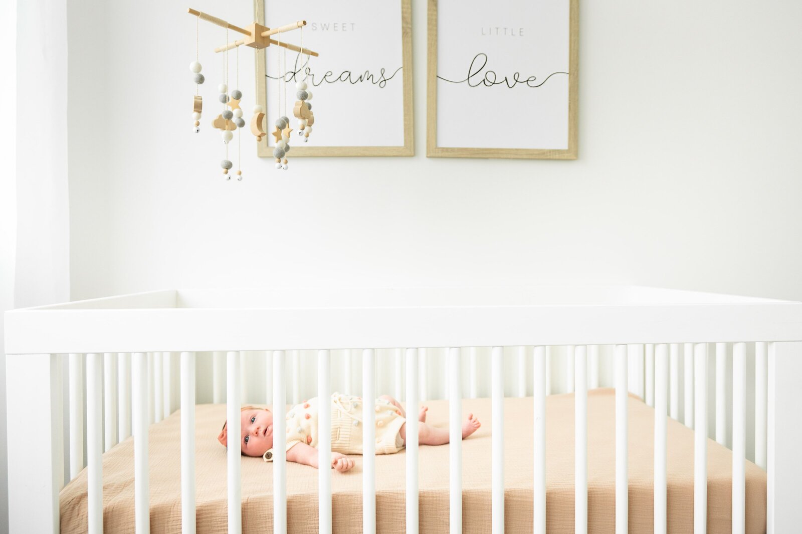 newborn baby in crib in a photography studio