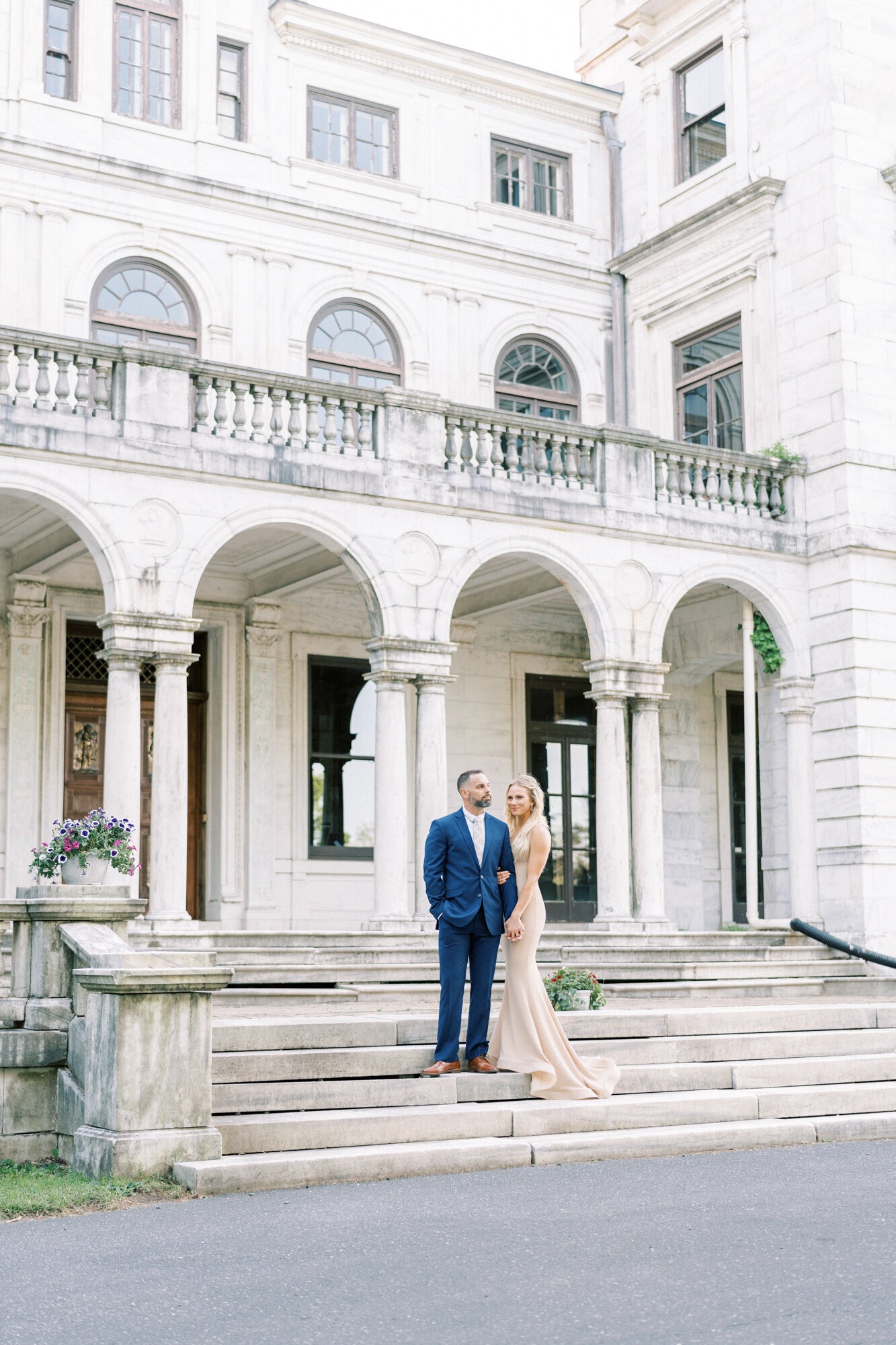Bride and groom stand on the steps of an estate in Washington DC