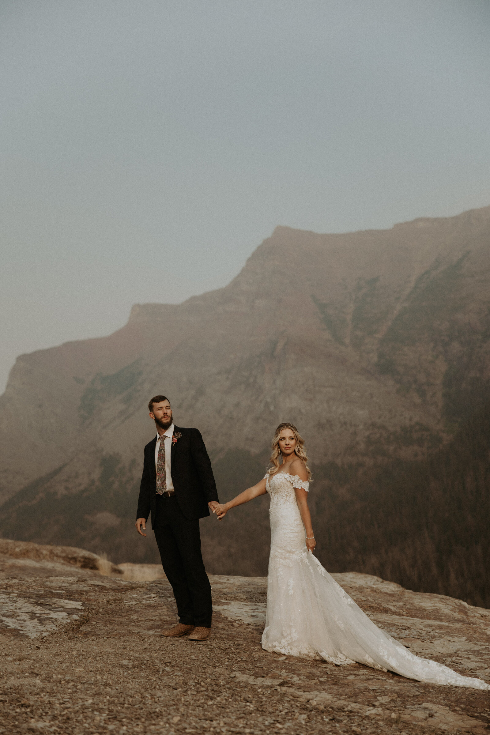 bride and groom holding hands during elopement in montana